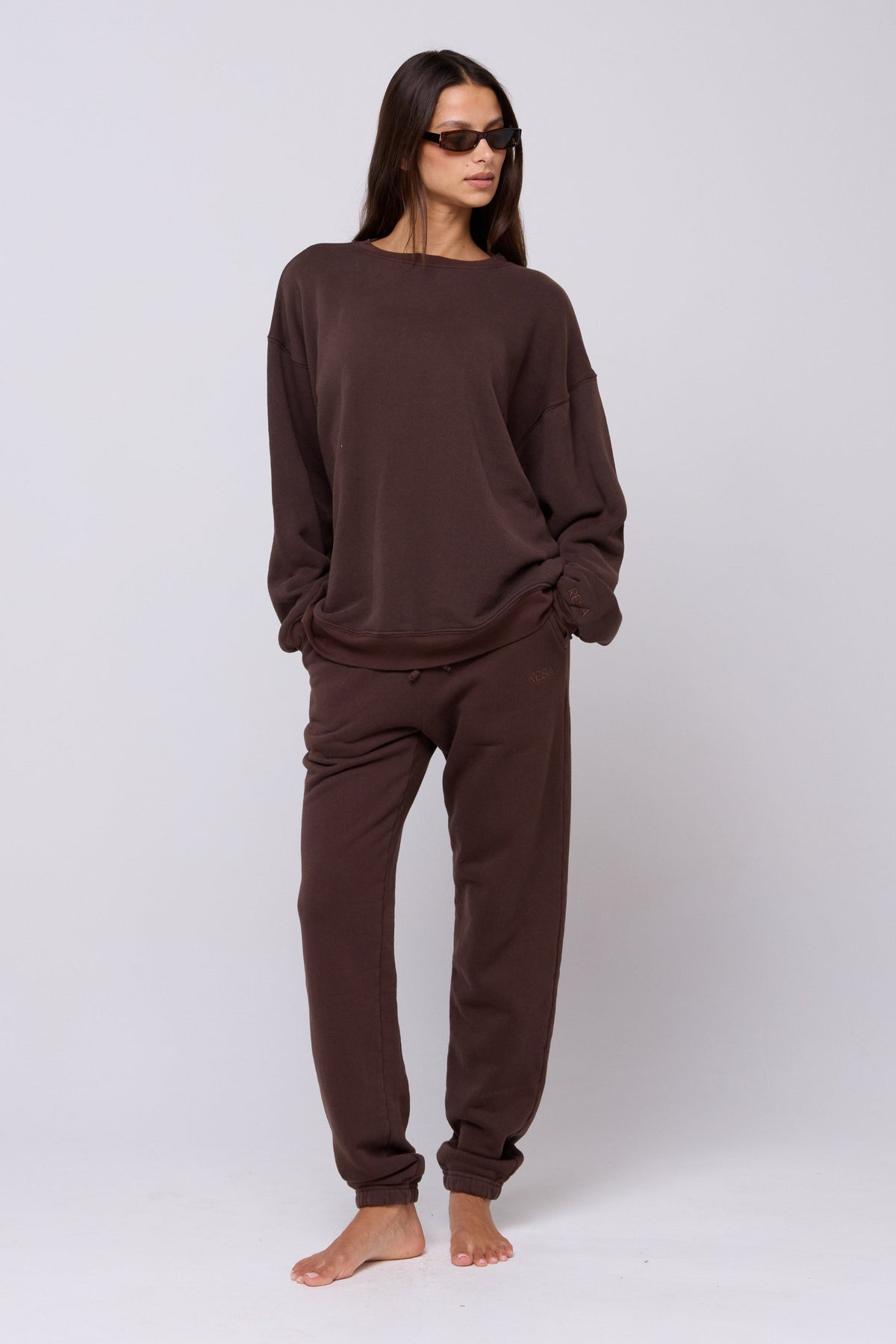 This is an image of Bodhi Sweatpants in Tobacco - RESA featuring a model wearing the dress