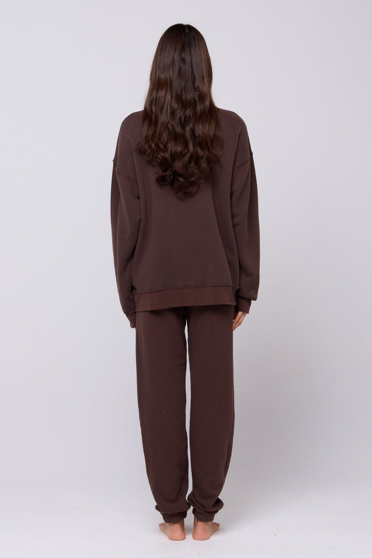 This is an image of Bodhi Sweatpants in Tobacco - RESA featuring a model wearing the dress