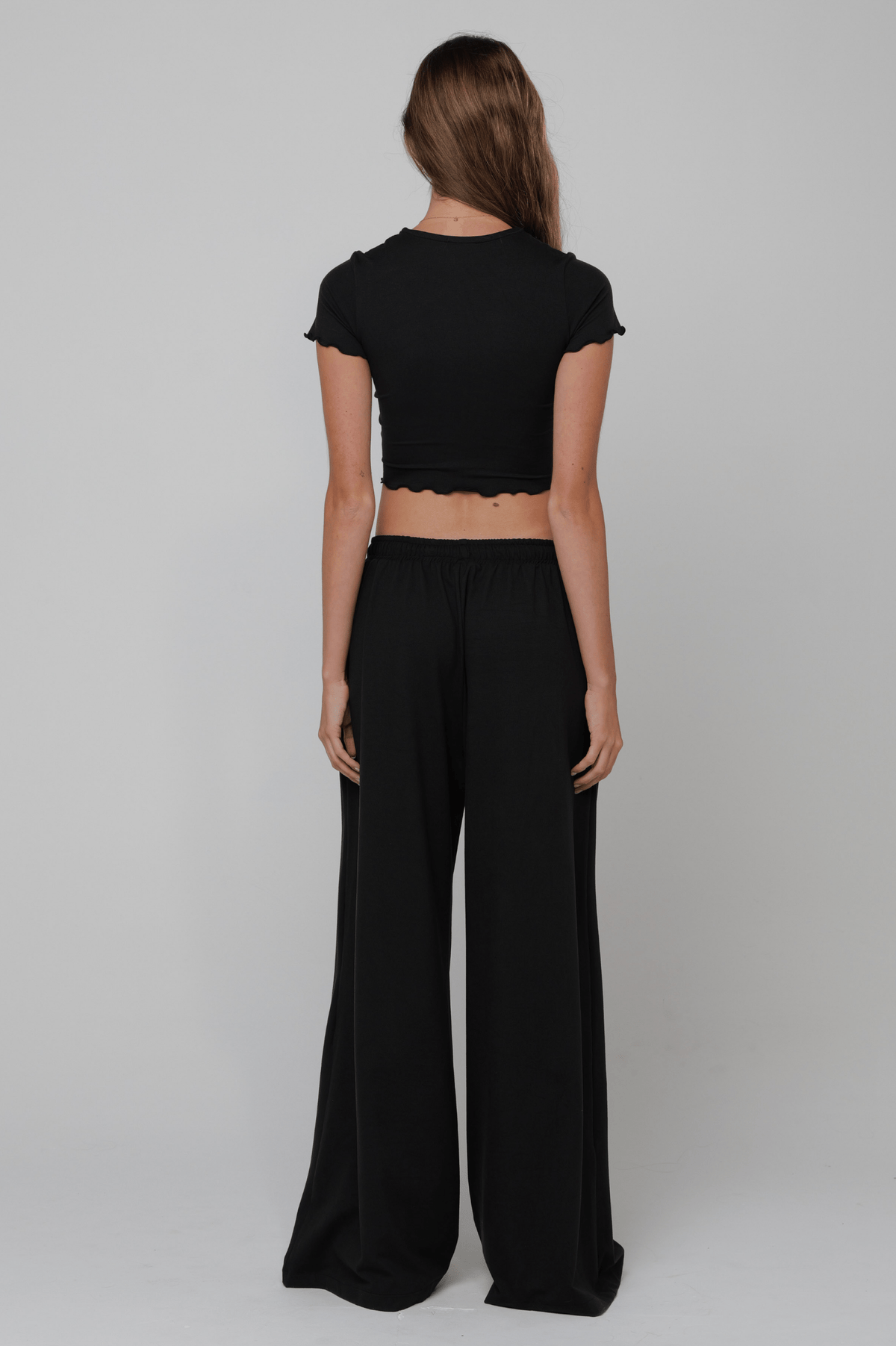 This is an image of Chase Pant Second Skin in Black - RESA featuring a model wearing the dress