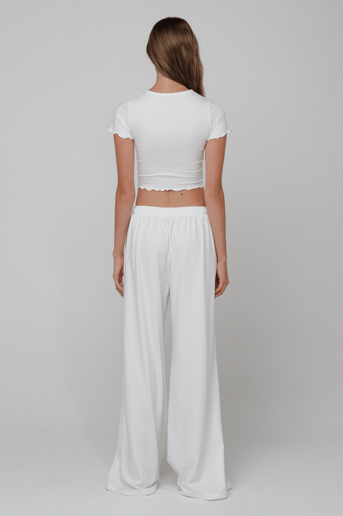 This is an image of Chase Pant Second Skin in White - RESA featuring a model wearing the dress
