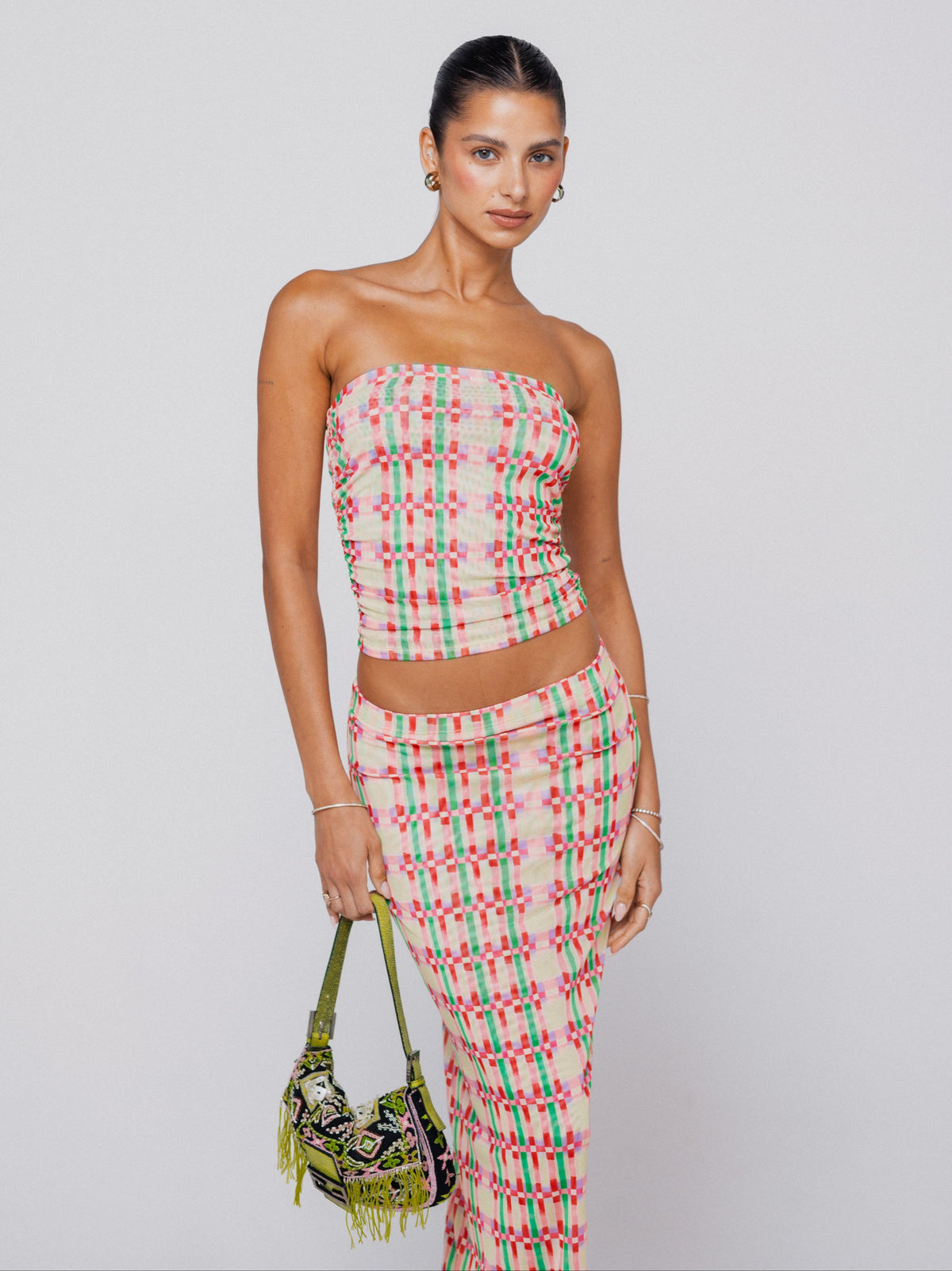 This is an image of Clyde Mesh Skirt in Plaid - RESA featuring a model wearing the dress