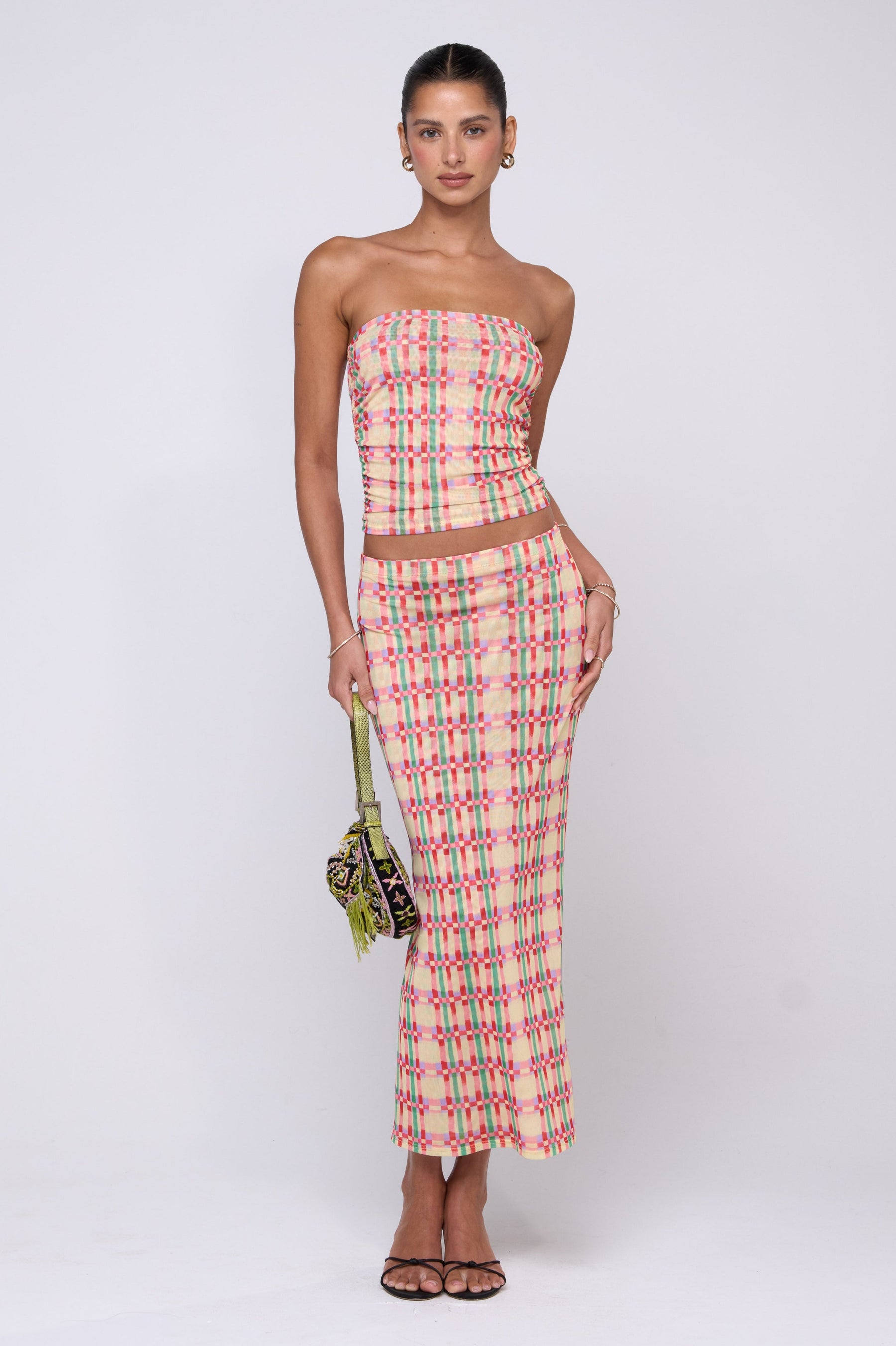 This is an image of Clyde Mesh Skirt in Plaid - RESA featuring a model wearing the dress