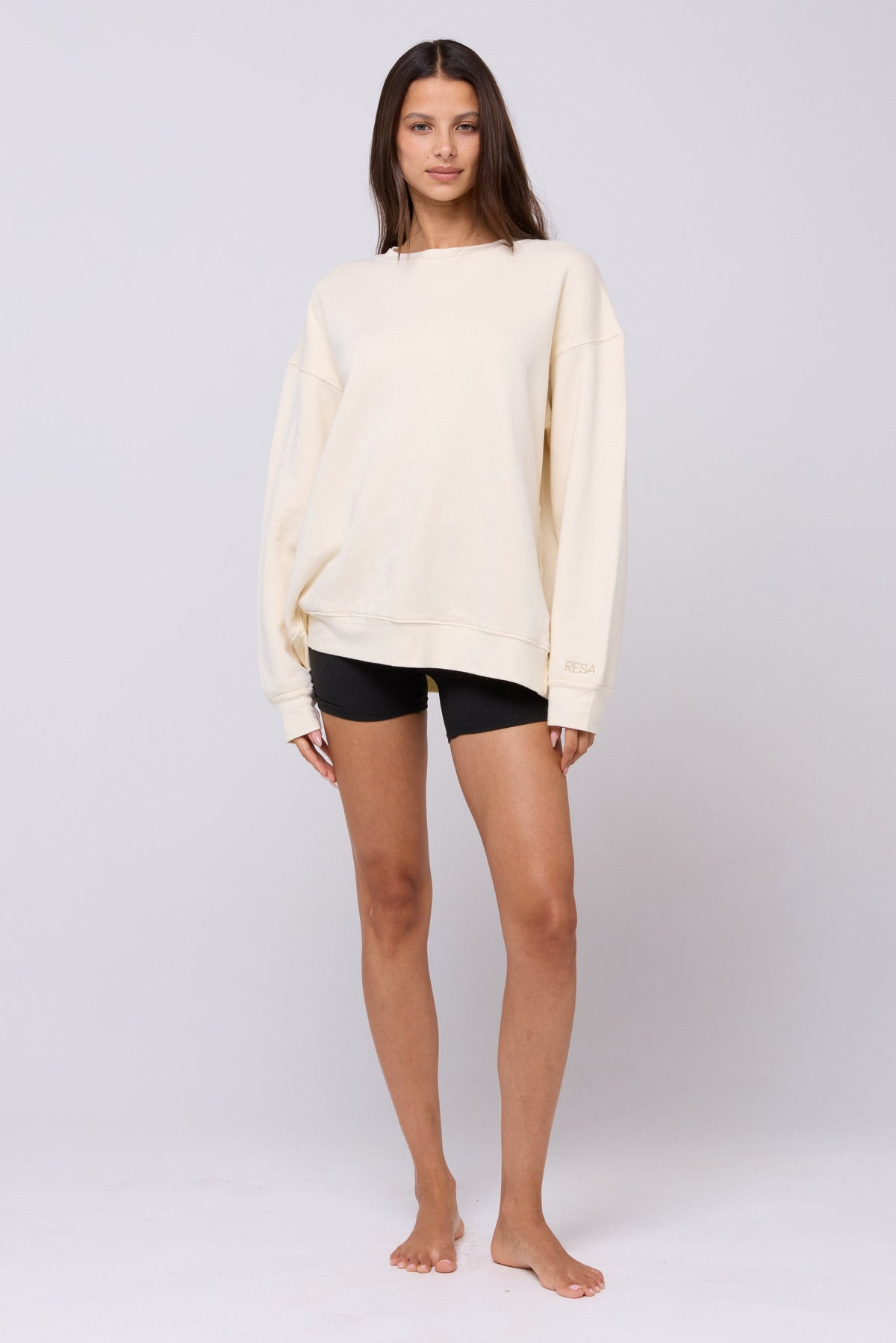 This is an image of Gunner Sweatshirt in Bone - RESA featuring a model wearing the dress
