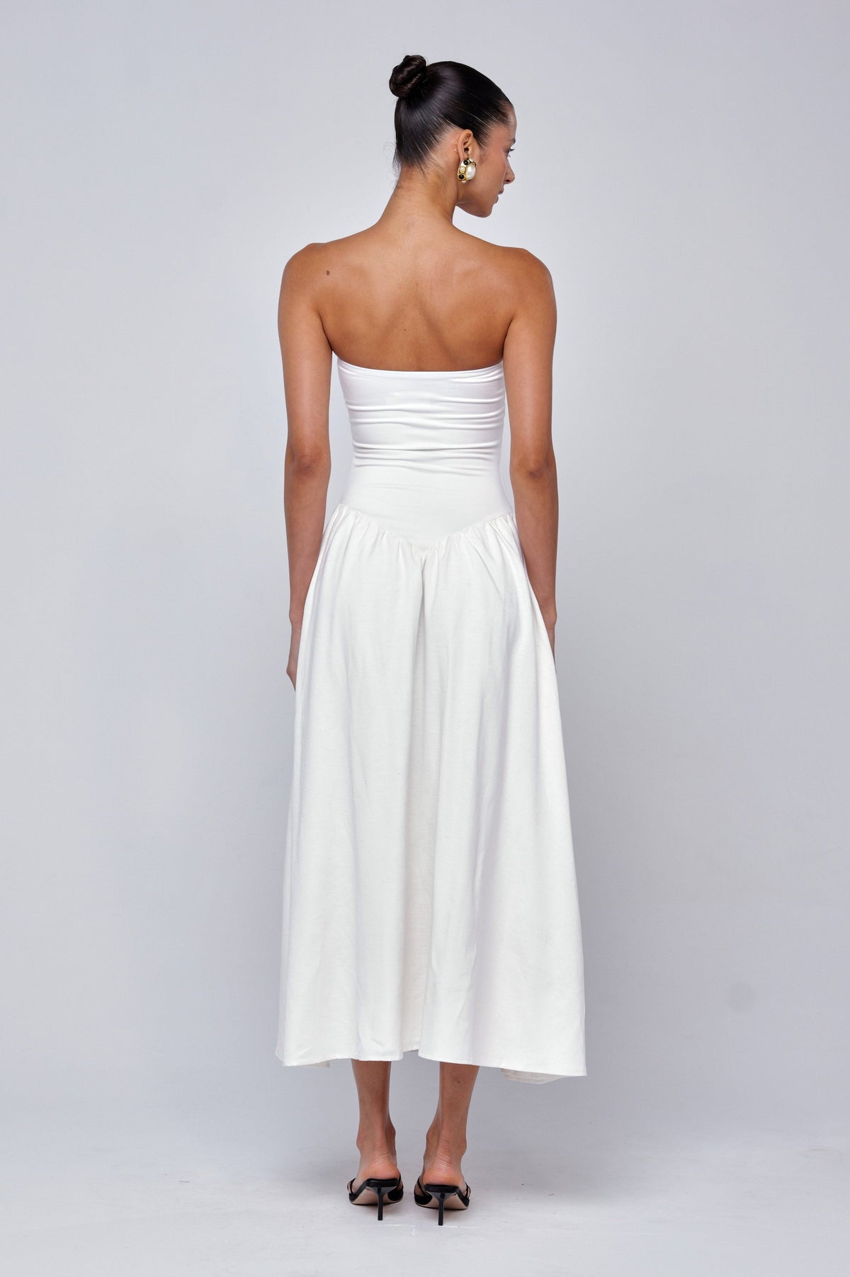 This is an image of Mackenzie Dress in White Linen - RESA featuring a model wearing the dress
