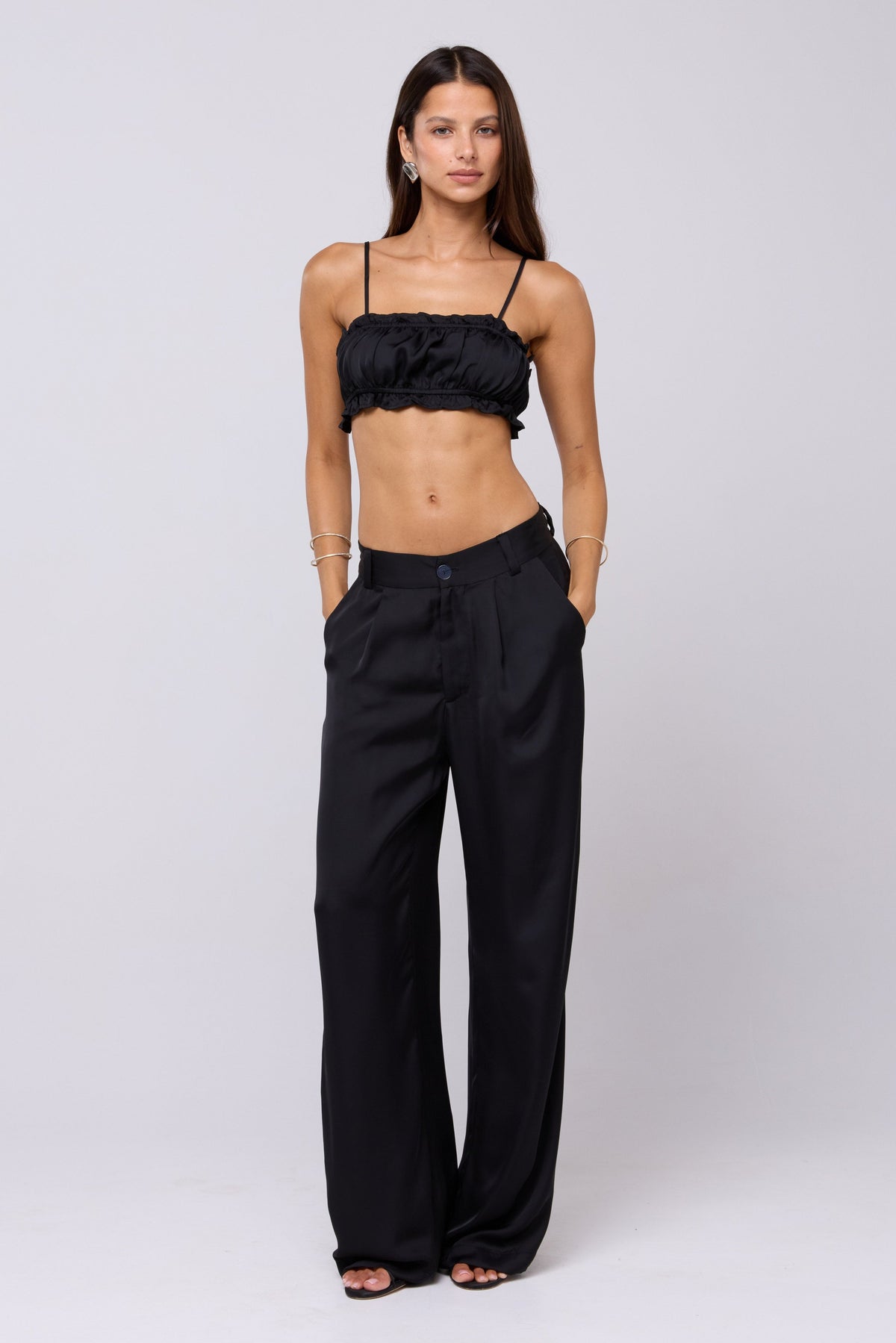 This is an image of Sasha Trouser in Black - RESA featuring a model wearing the dress