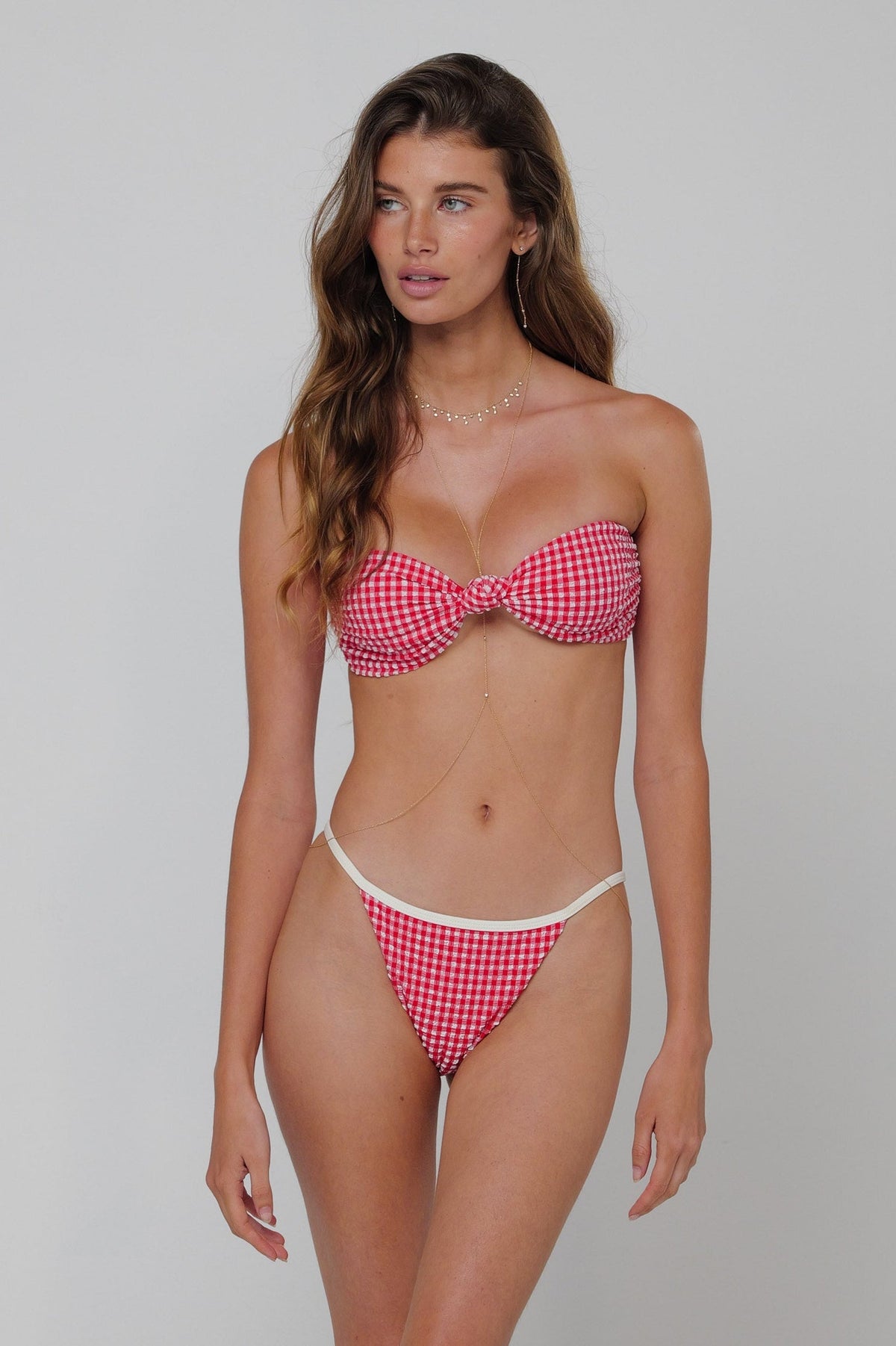 This is an image of Spencer Bikini Top in Red Gingham - RESA featuring a model wearing the dress