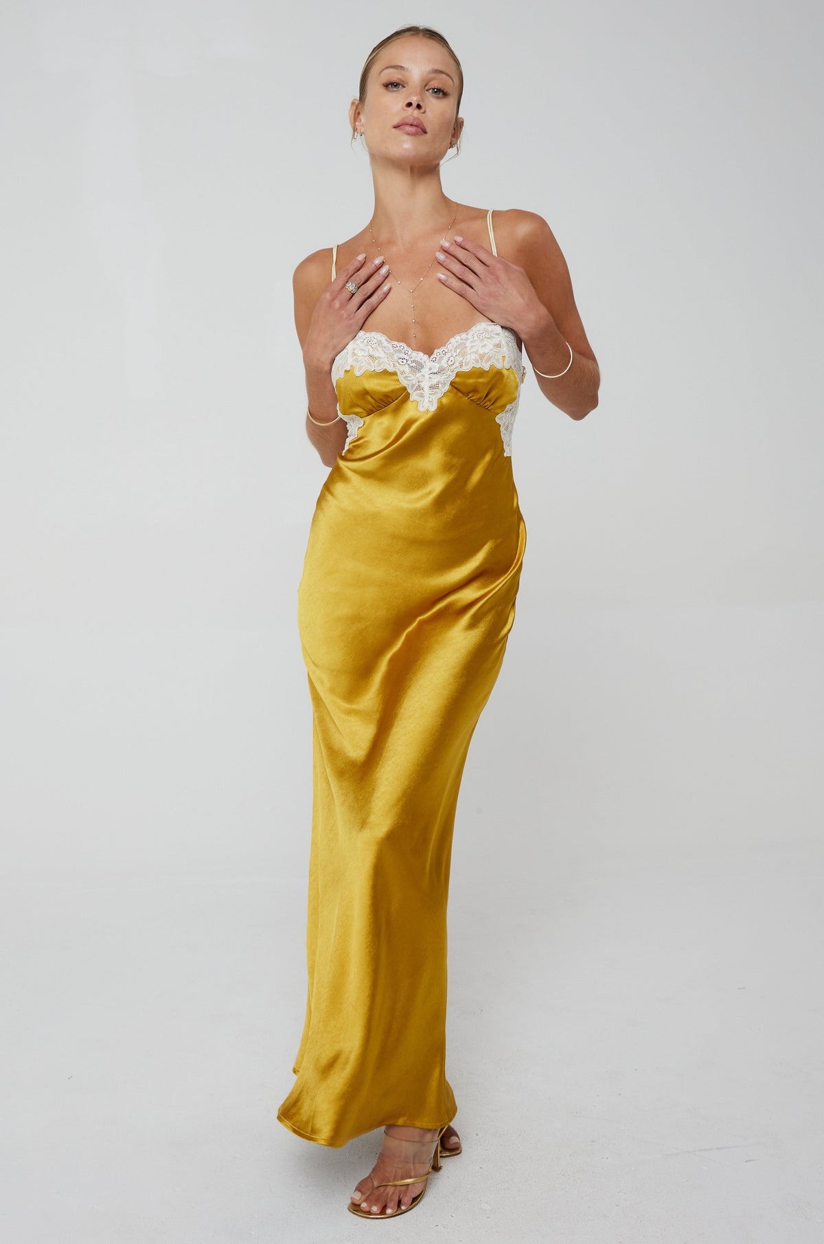 This is an image of Celine Dress in Gold - RESA featuring a model wearing the dress