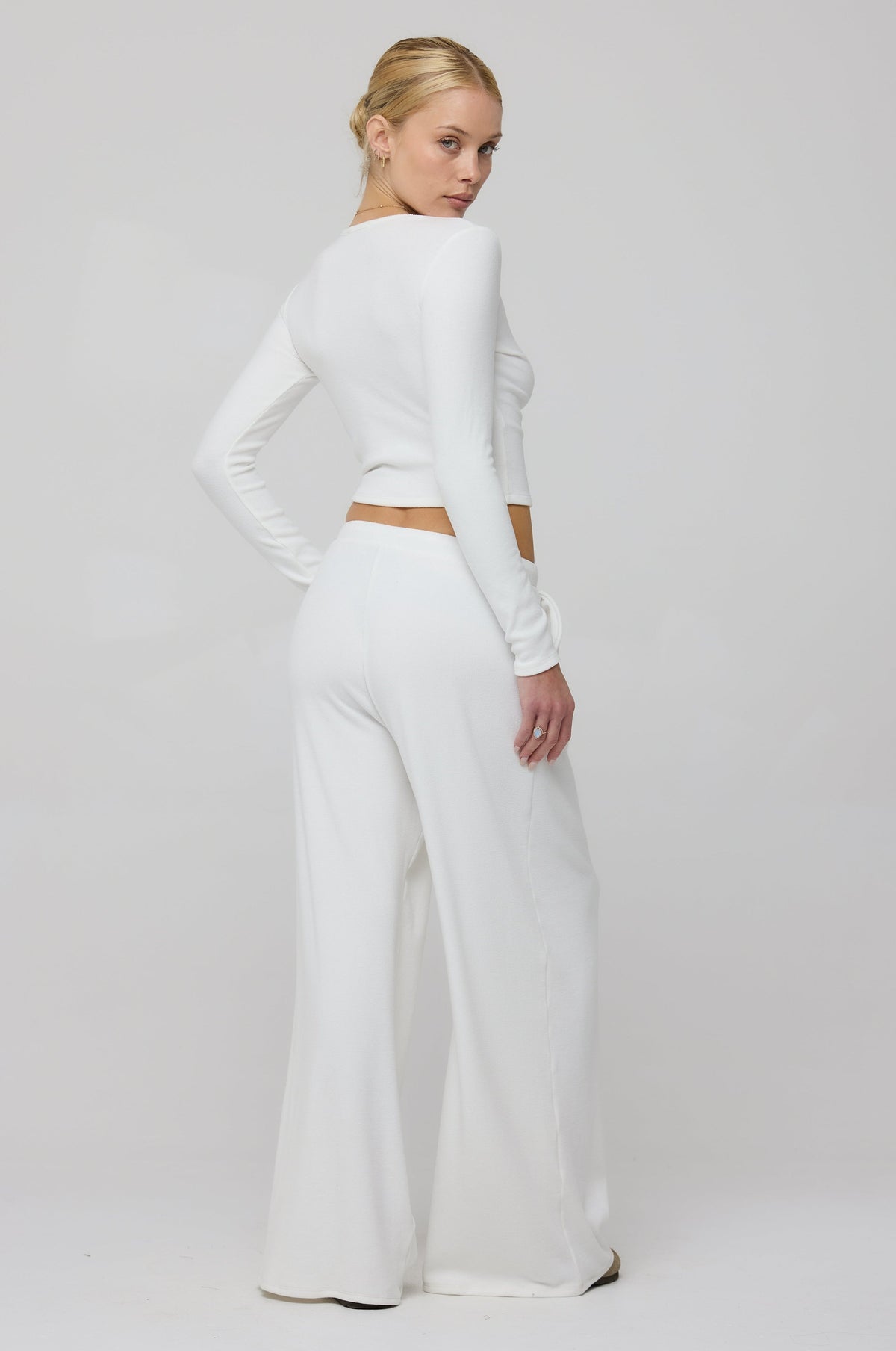 This is an image of Chase Rib Pant in White - RESA featuring a model wearing the dress