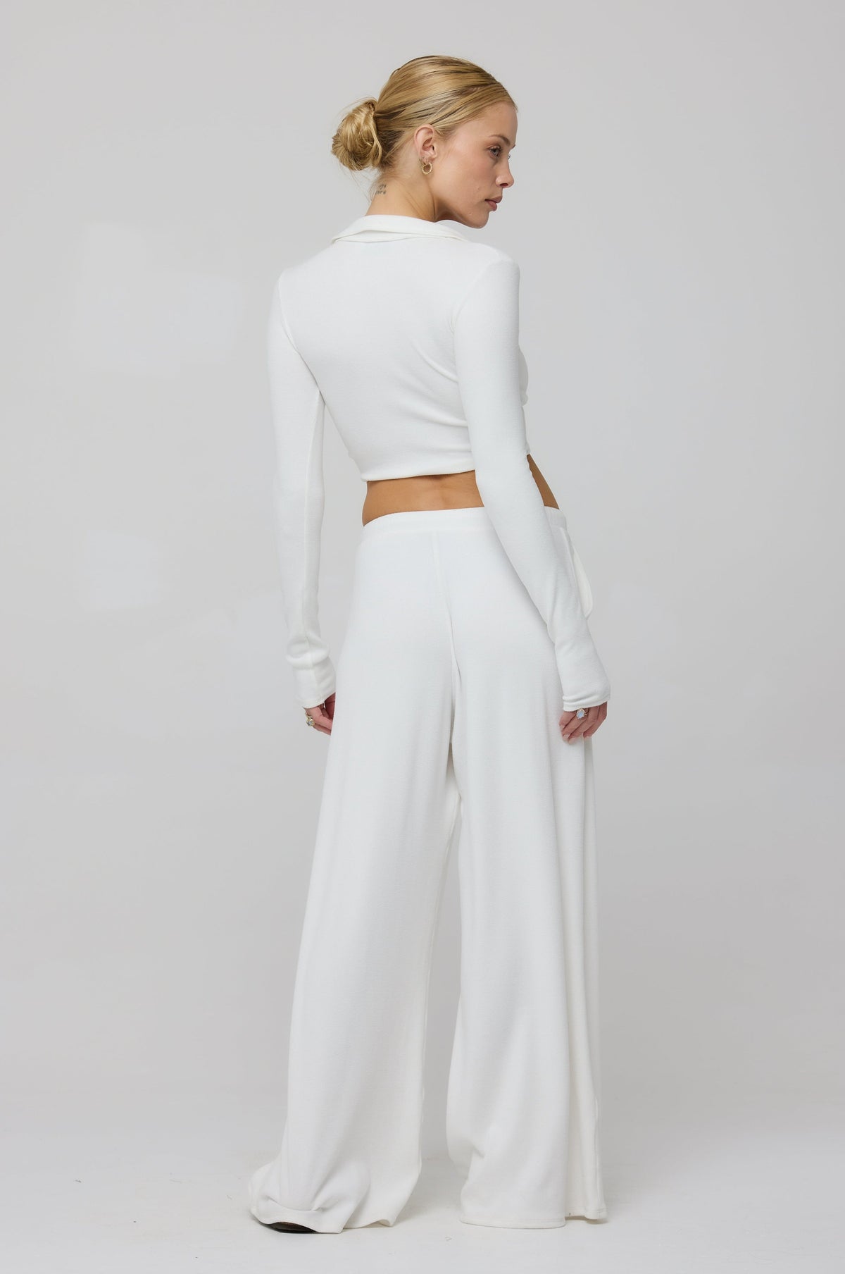 This is an image of Chase Rib Pant in White - RESA featuring a model wearing the dress