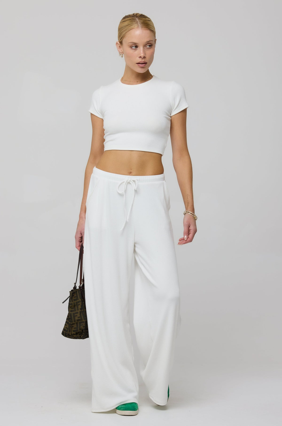 This is an image of Chase Rib Pant in White - RESA featuring a model wearing the dress