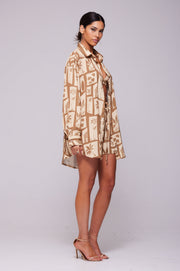 This is an image of Monica Blouse in Trestles - RESA featuring a model wearing the dress