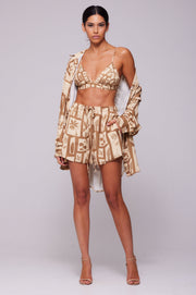 This is an image of Monica Blouse in Trestles - RESA featuring a model wearing the dress