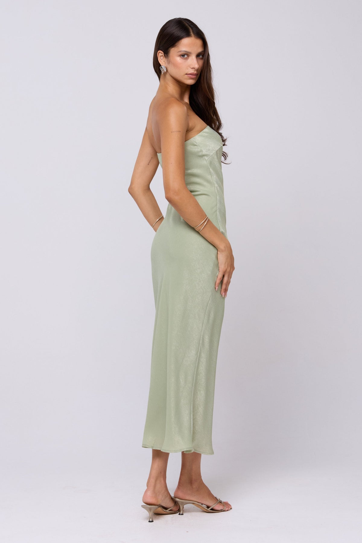 This is an image of Anna Slip in Sage - RESA featuring a model wearing the dress