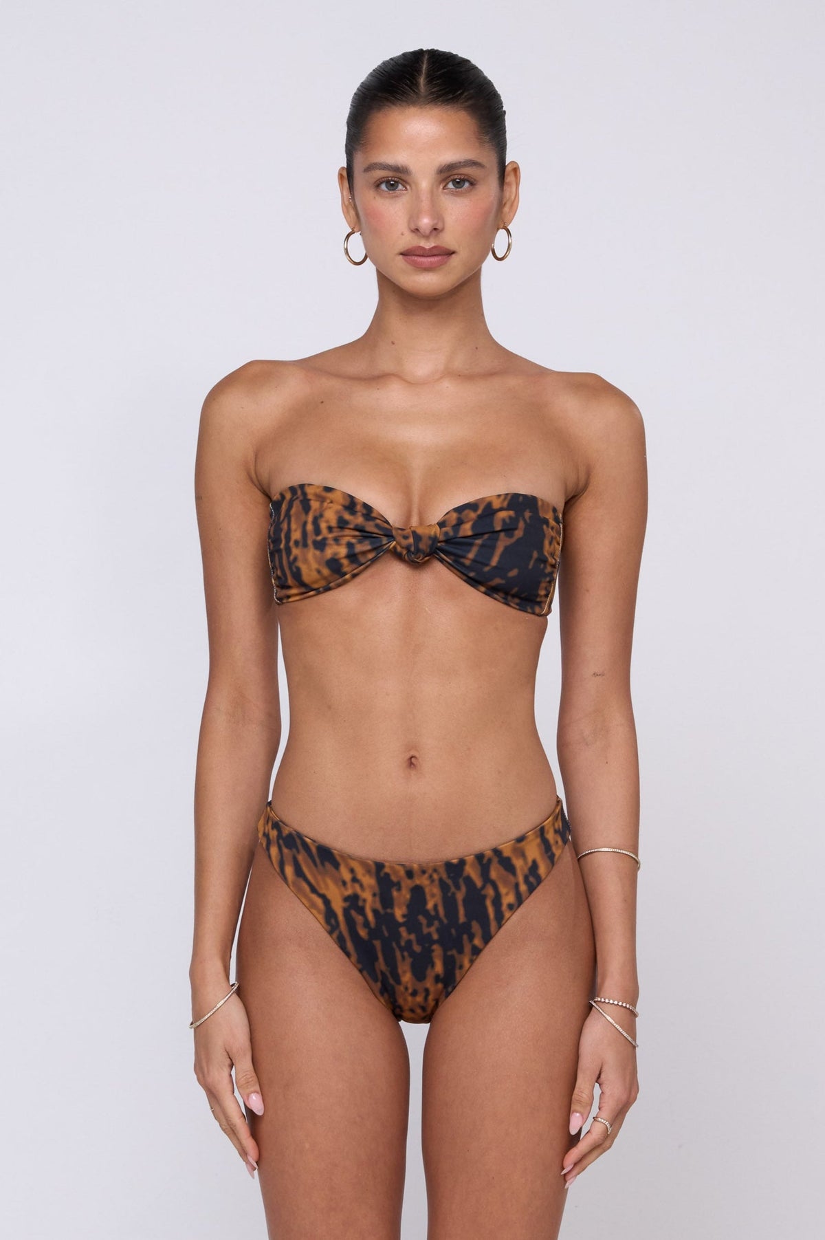 This is an image of Beau Bikini Bottom in Bond - RESA featuring a model wearing the dress