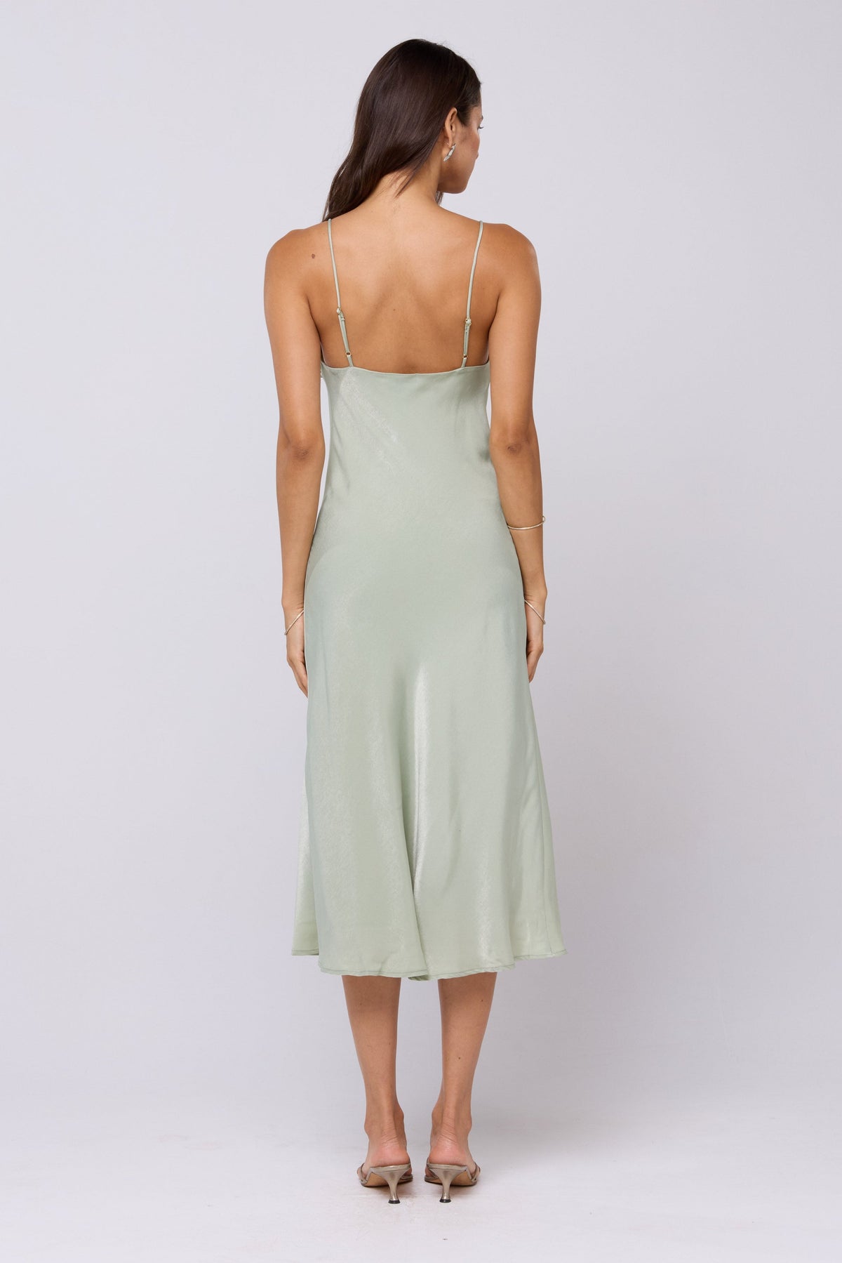 This is an image of Berri Slip in Sage - RESA featuring a model wearing the dress