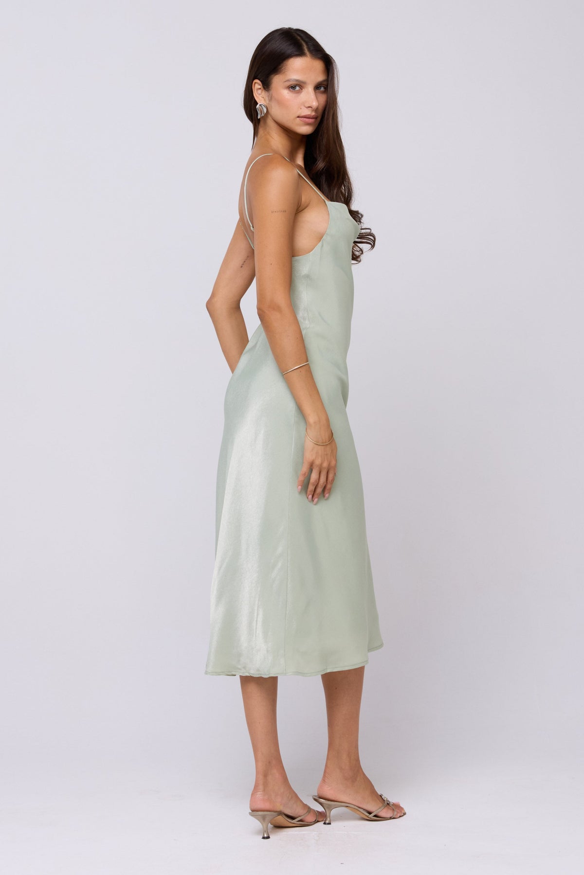 This is an image of Berri Slip in Sage - RESA featuring a model wearing the dress