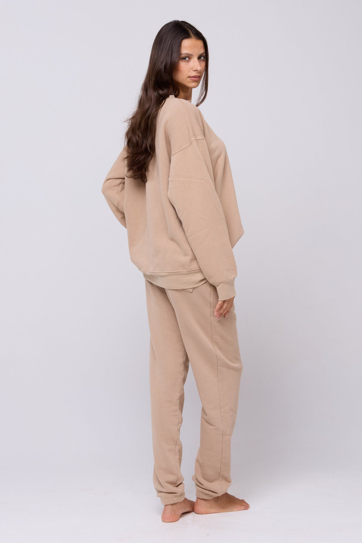 This is an image of Bodhi Sweatpants in Sand - RESA featuring a model wearing the dress