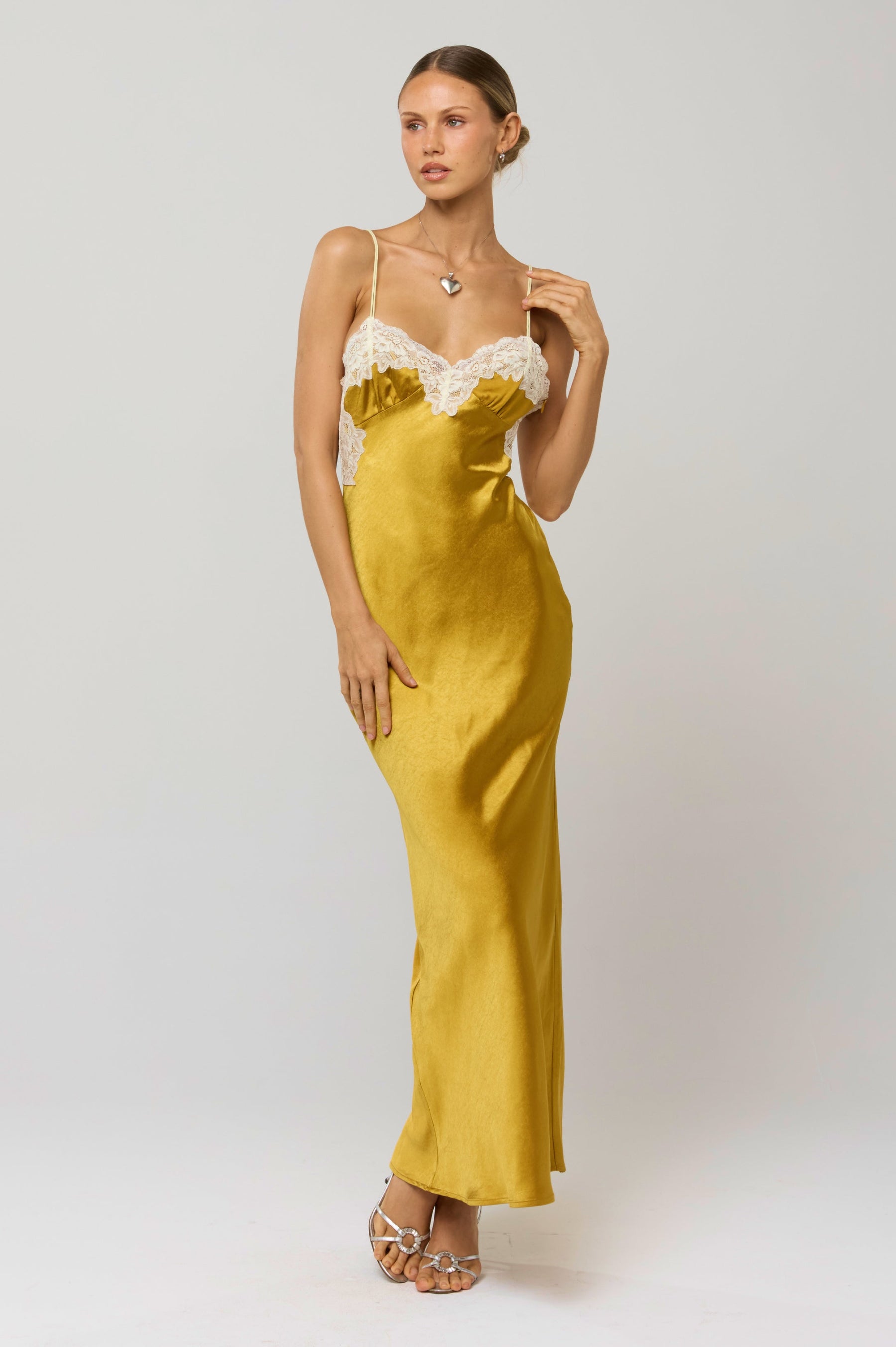 This is an image of Celine Dress in Gold - RESA featuring a model wearing the dress