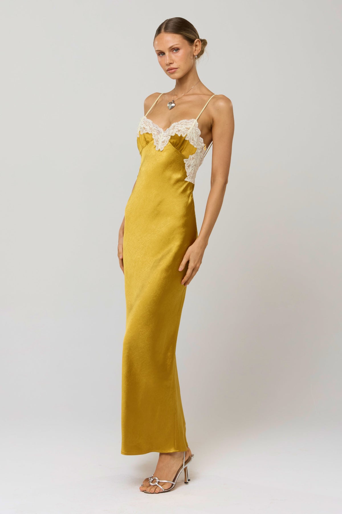 This is an image of Celine Dress in Gold - RESA featuring a model wearing the dress