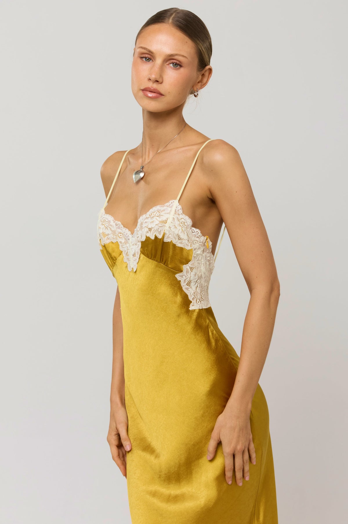 This is an image of Celine Dress in Gold - RESA featuring a model wearing the dress