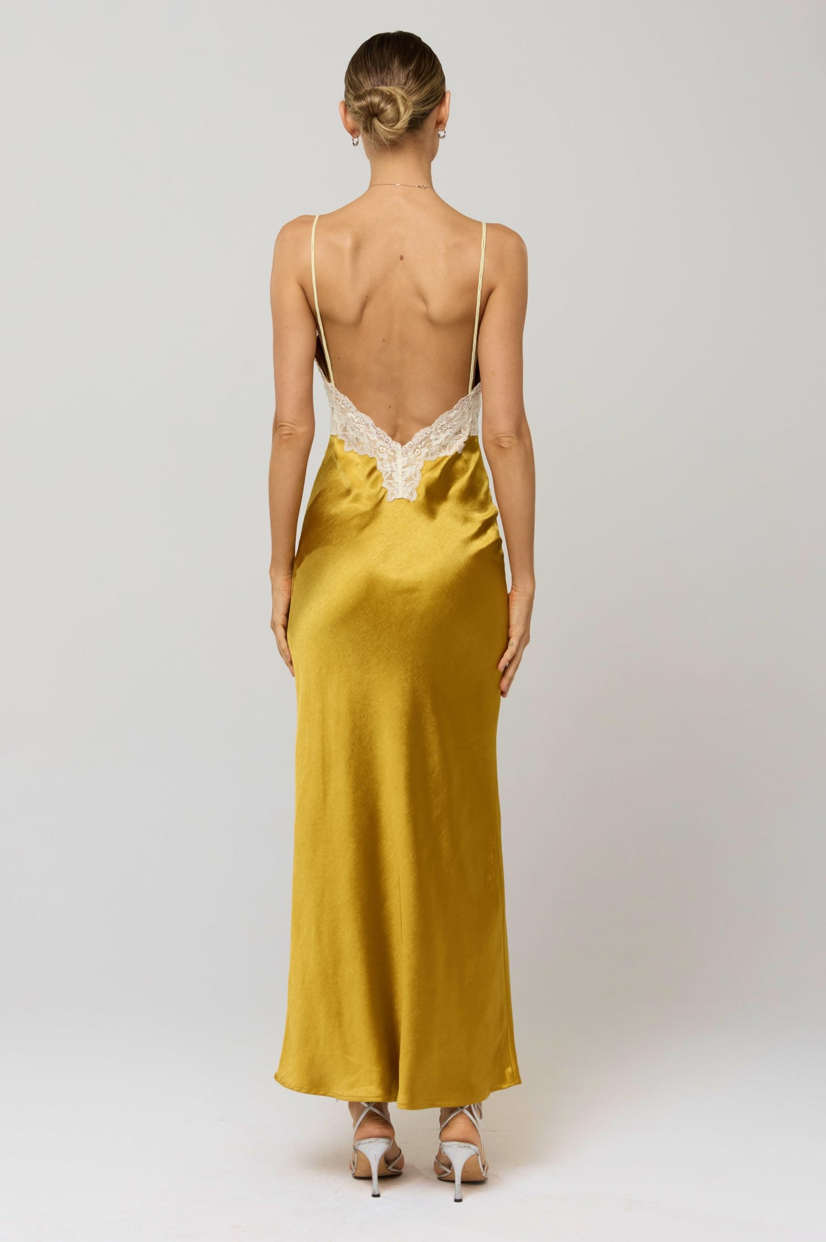 This is an image of Celine Dress in Gold - RESA featuring a model wearing the dress
