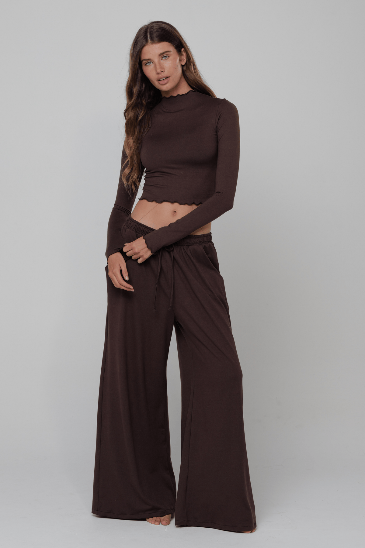 This is an image of Chase Pant Second Skin in Cacoa - RESA featuring a model wearing the dress