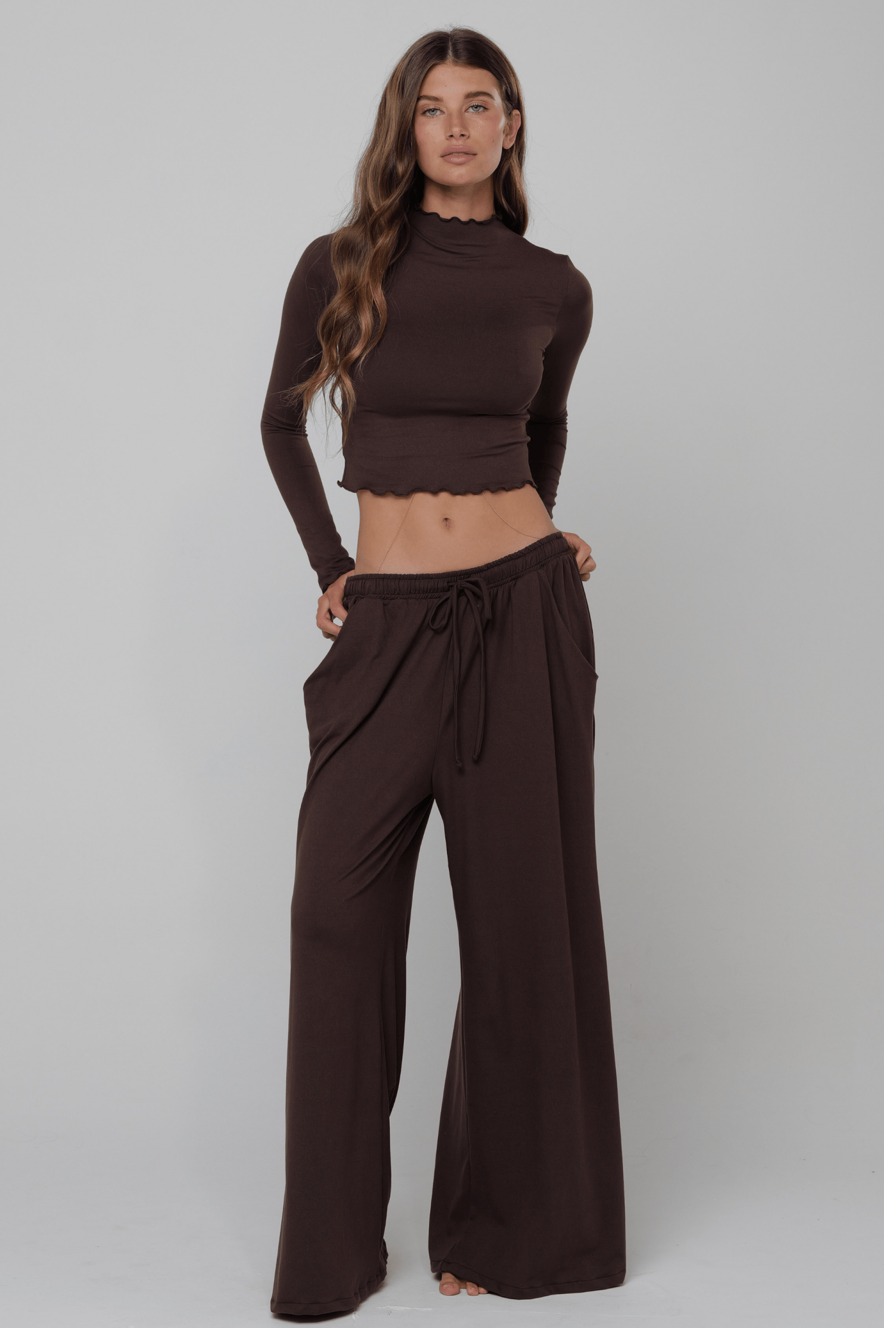 This is an image of Chase Pant Second Skin in Cacoa - RESA featuring a model wearing the dress