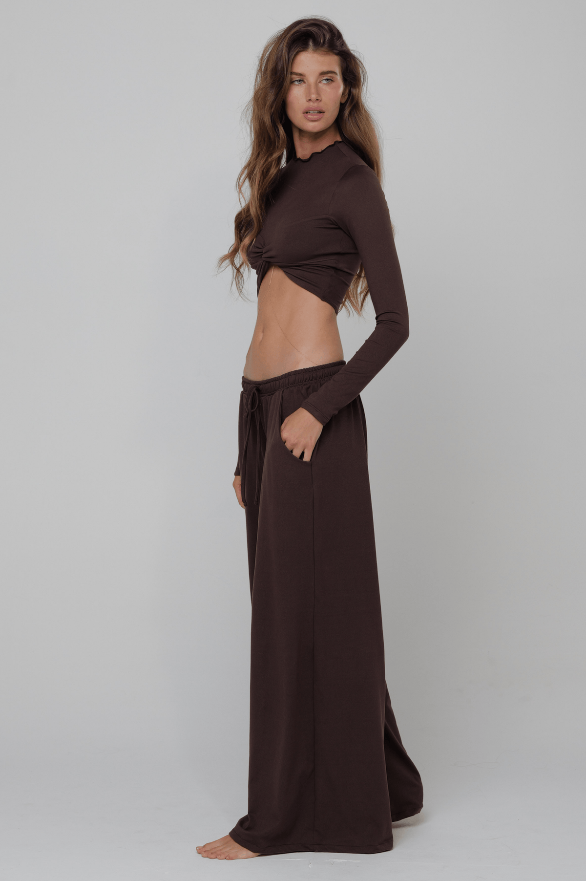 This is an image of Chase Pant Second Skin in Cacoa - RESA featuring a model wearing the dress