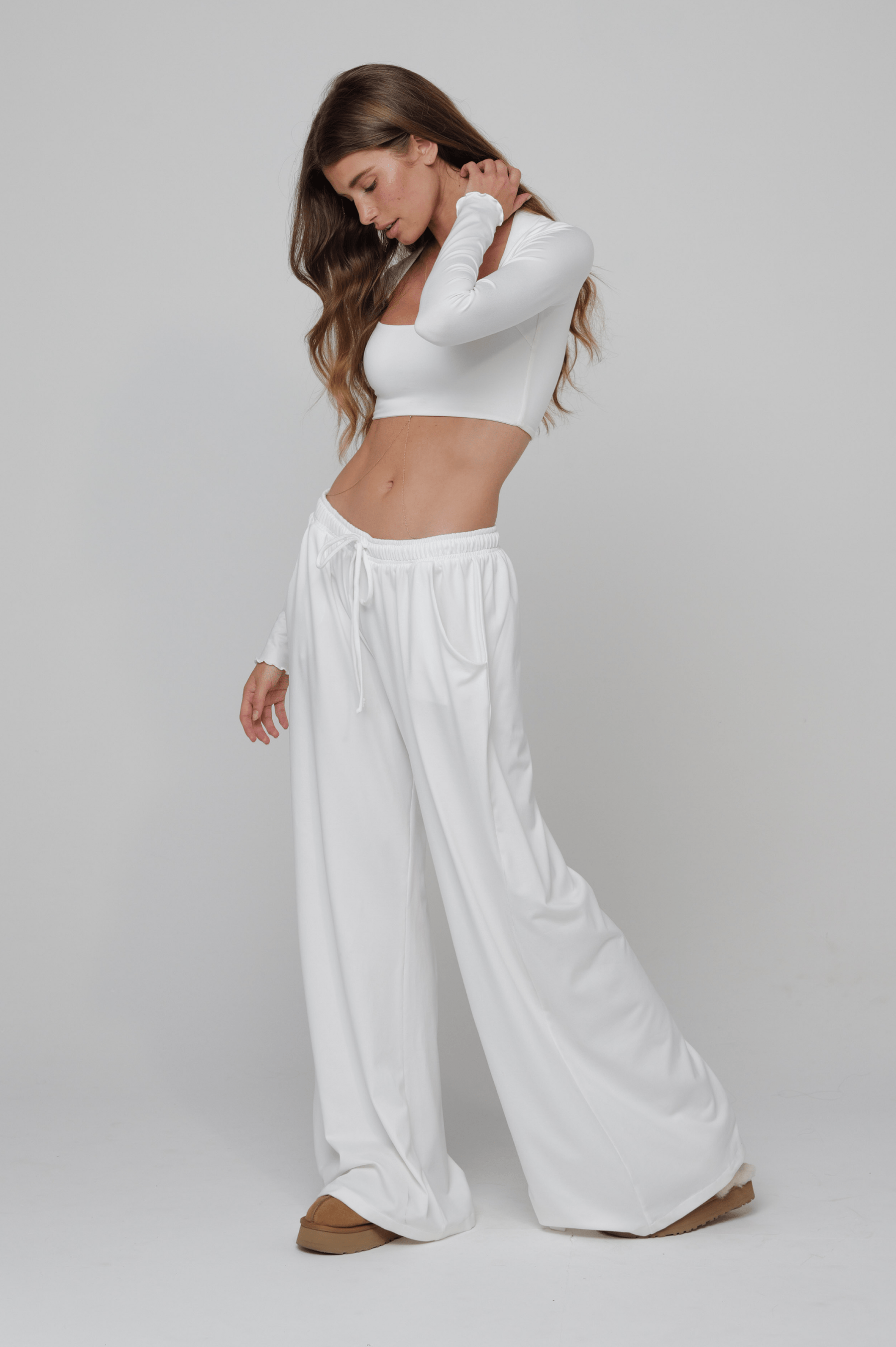This is an image of Chase Pant Second Skin in White - RESA featuring a model wearing the dress