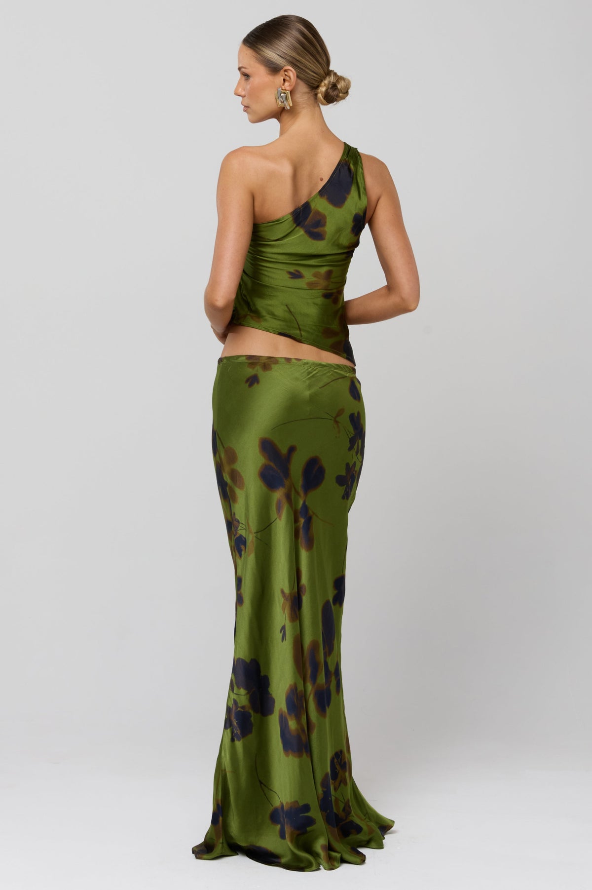 This is an image of Crystal Top in Evergreen - RESA featuring a model wearing the dress