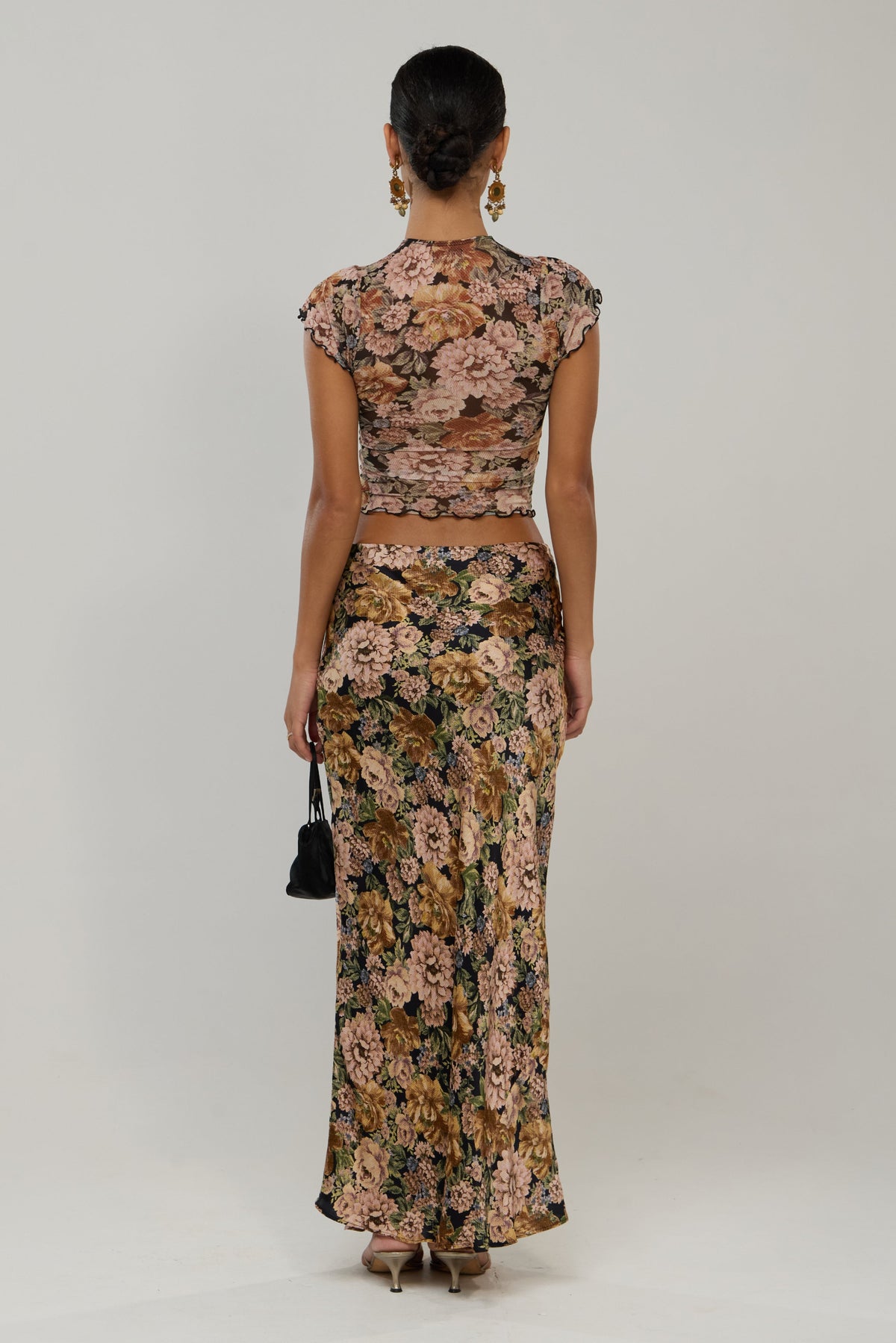 This is an image of Desi in Antique - RESA featuring a model wearing the dress