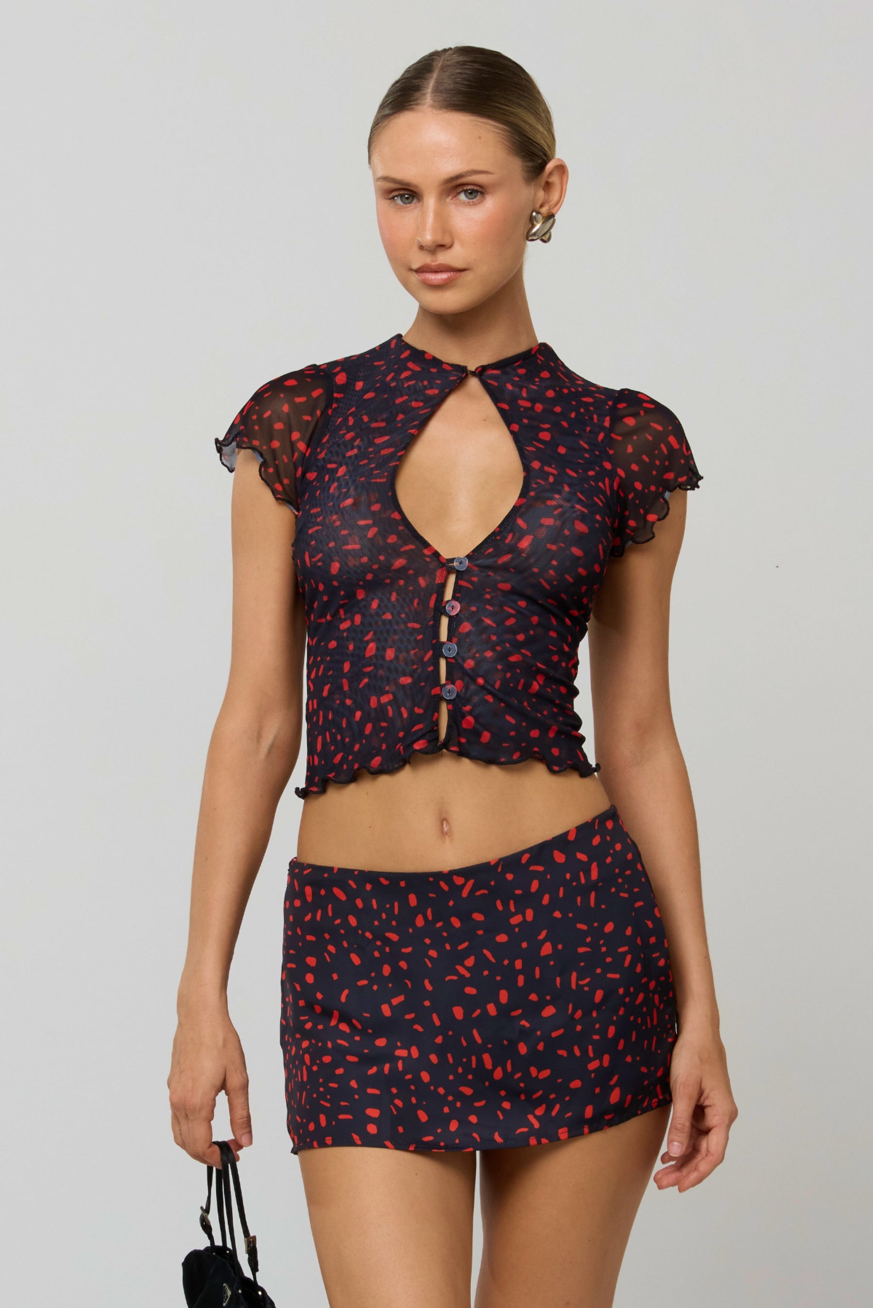 This is an image of Desi Top in Rouge - RESA featuring a model wearing the dress