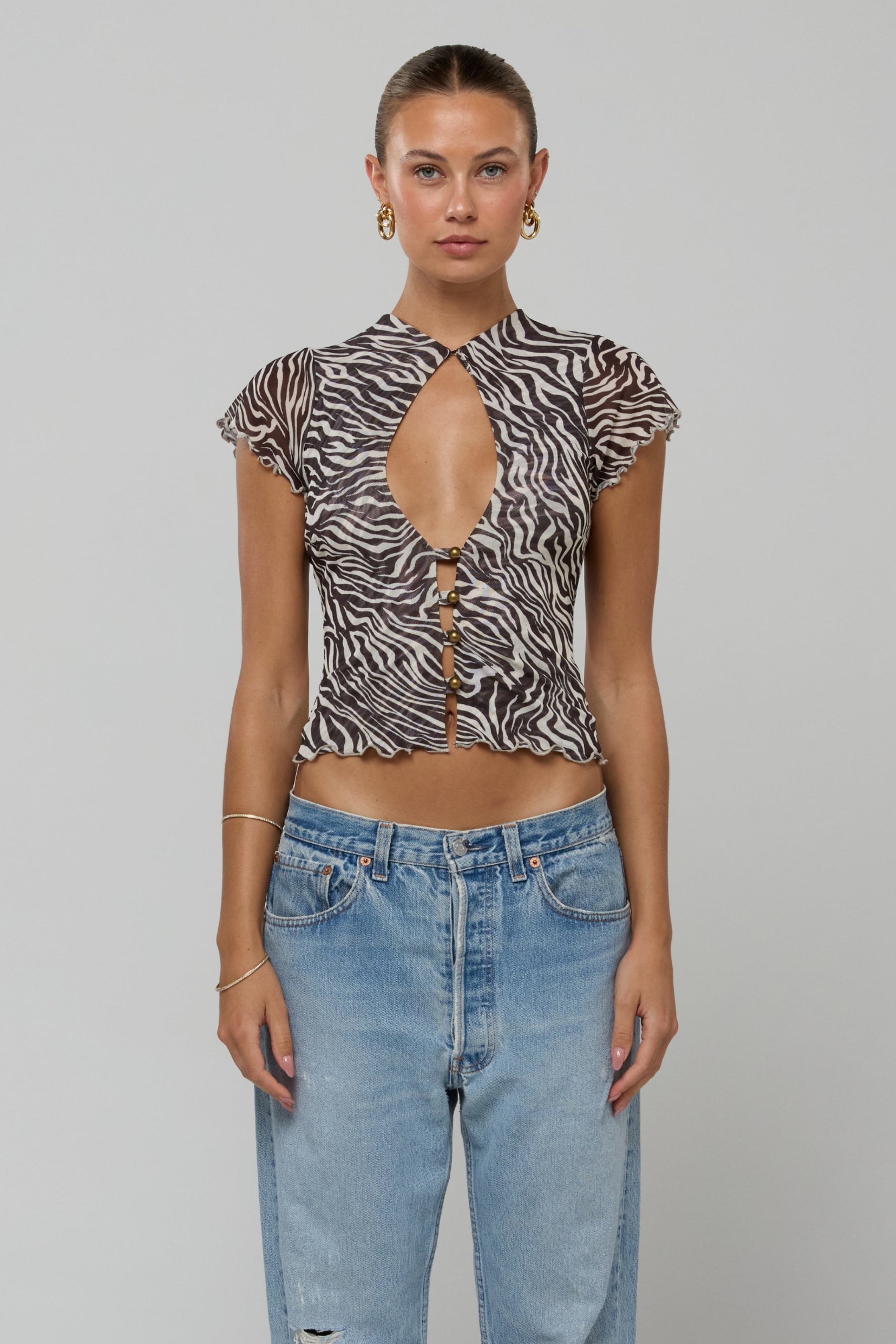 This is an image of Desi Top in Selva - RESA featuring a model wearing the dress