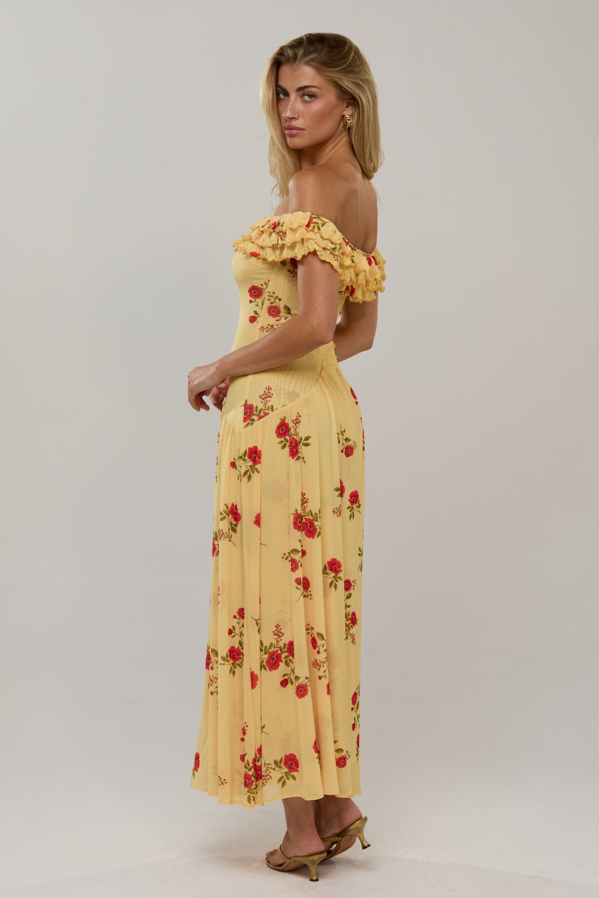 This is an image of Dolly Dress in Saffron - RESA featuring a model wearing the dress