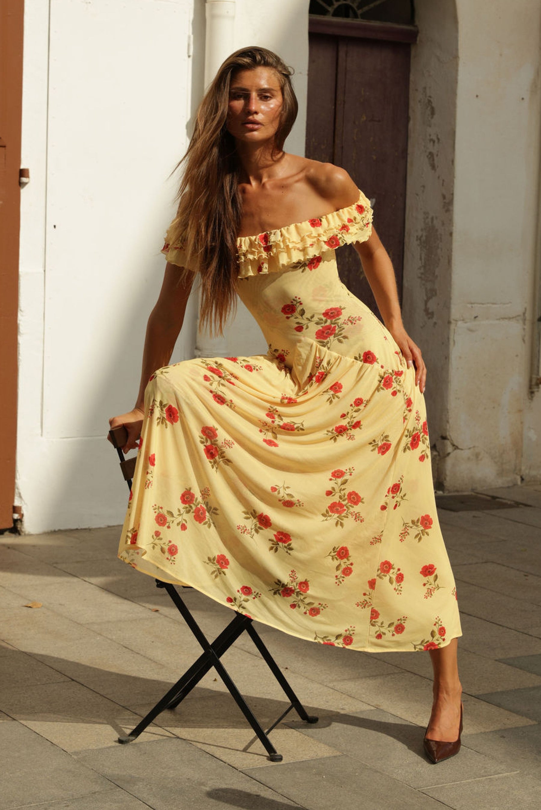 This is an image of Dolly Dress in Saffron - RESA featuring a model wearing the dress