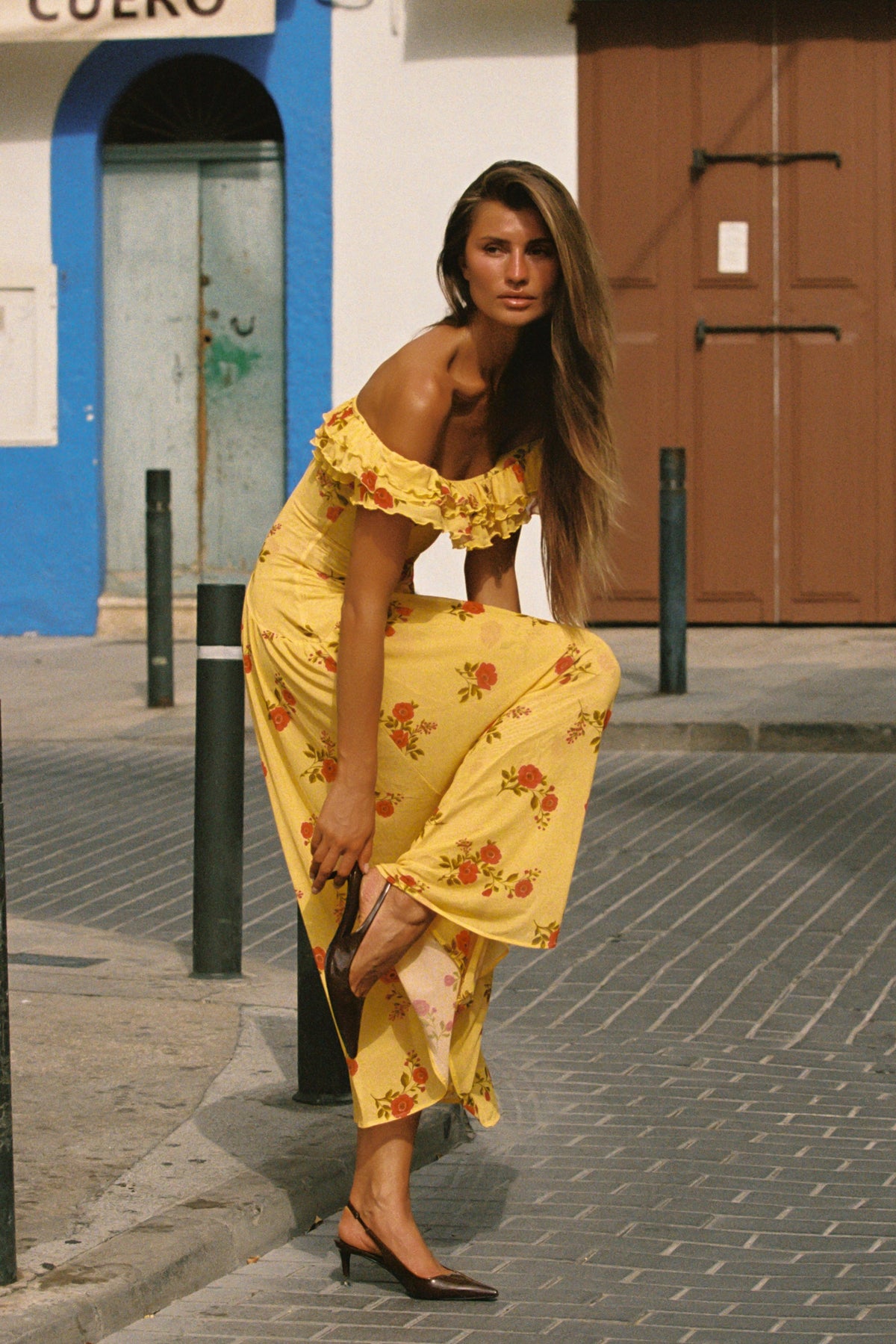 This is an image of Dolly Dress in Saffron - RESA featuring a model wearing the dress