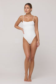 This is an image of Dominick One Piece Swimsuit in White - RESA featuring a model wearing the dress