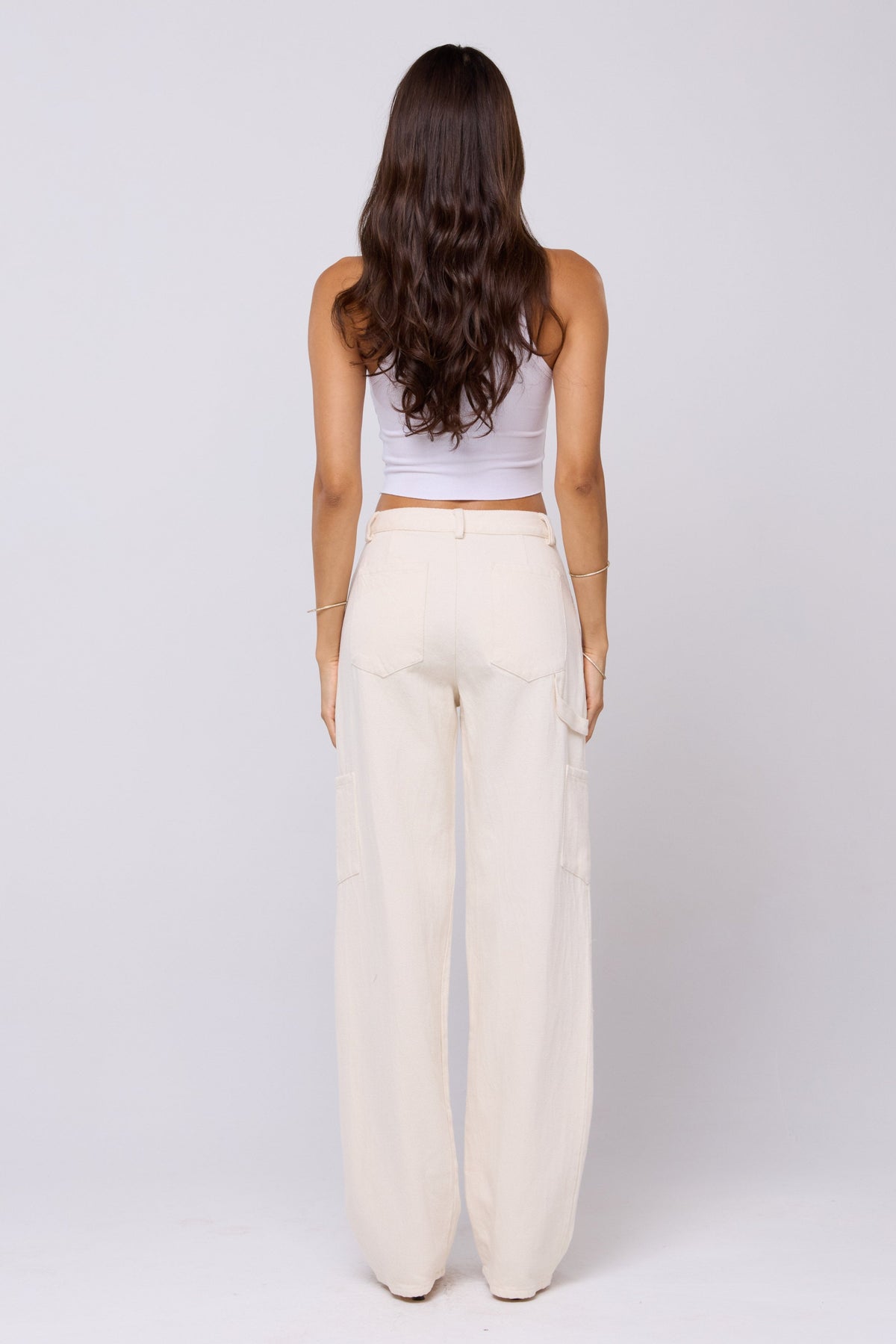 This is an image of Elsa Cargo Pant in Cream - RESA featuring a model wearing the dress