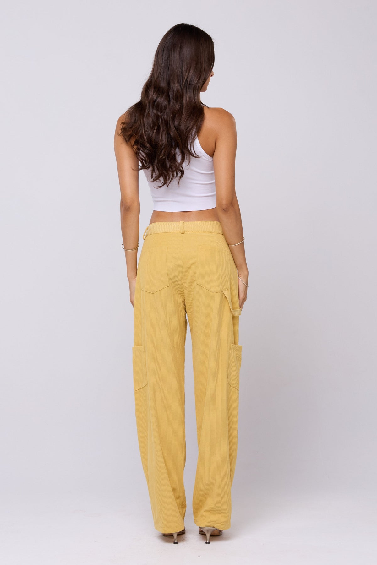 This is an image of Elsa Cargo Pant in Mustard - RESA featuring a model wearing the dress