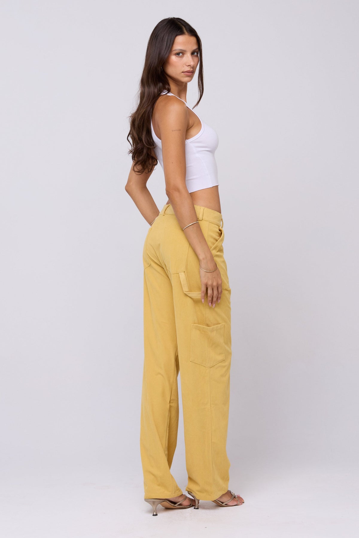 This is an image of Elsa Cargo Pant in Mustard - RESA featuring a model wearing the dress