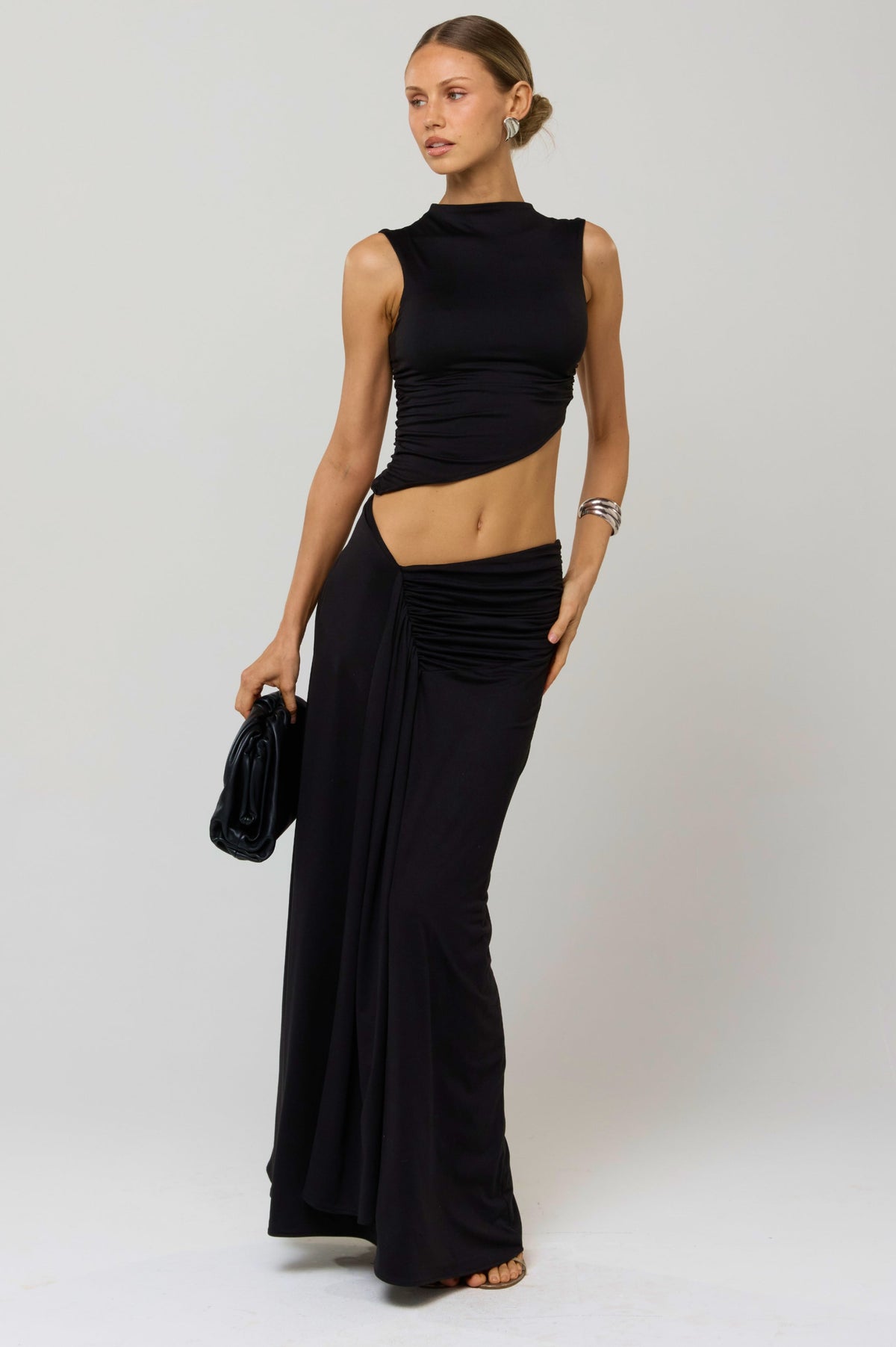 This is an image of Estelle Skirt in Black Knit - RESA featuring a model wearing the dress