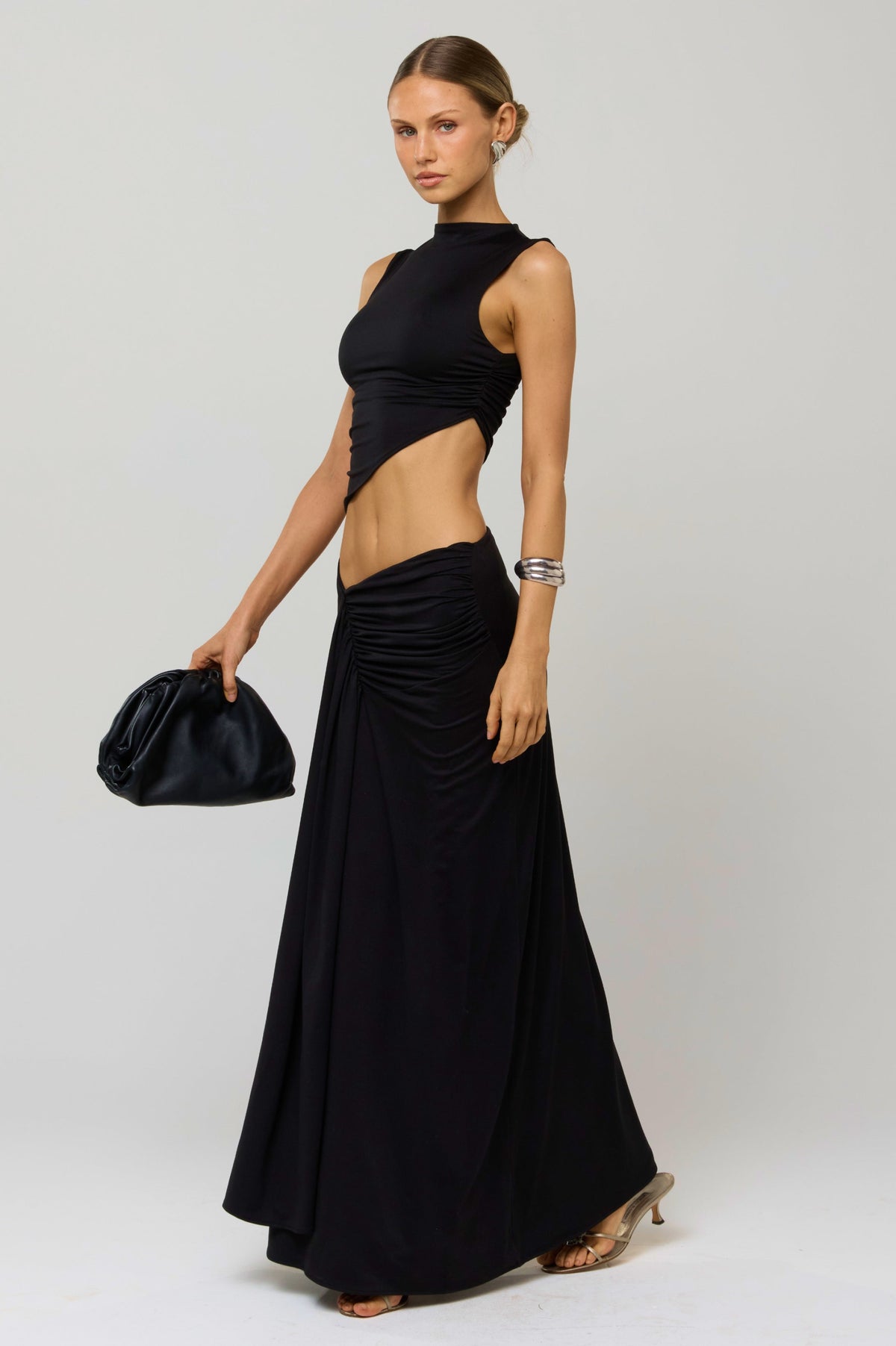This is an image of Estelle Skirt in Black Knit - RESA featuring a model wearing the dress
