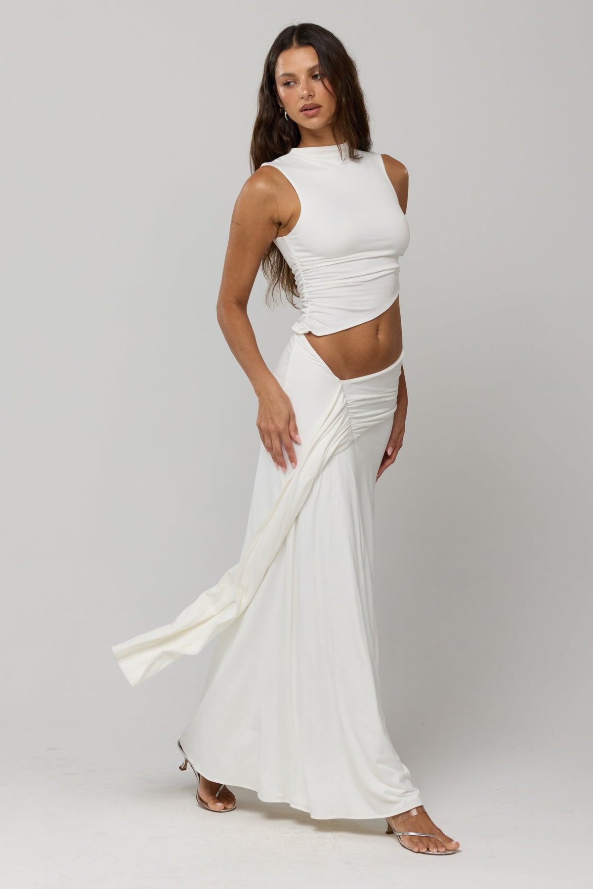 This is an image of Estelle Skirt in White Knit - RESA featuring a model wearing the dress