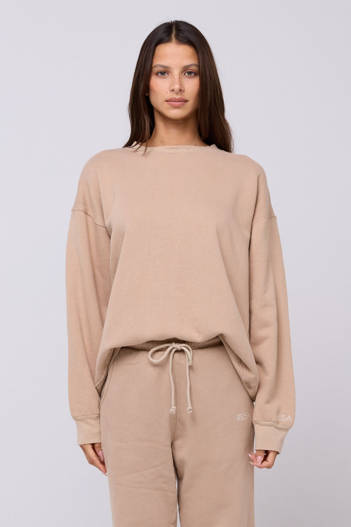 This is an image of Gunner Sweatshirt in Sand - RESA featuring a model wearing the dress