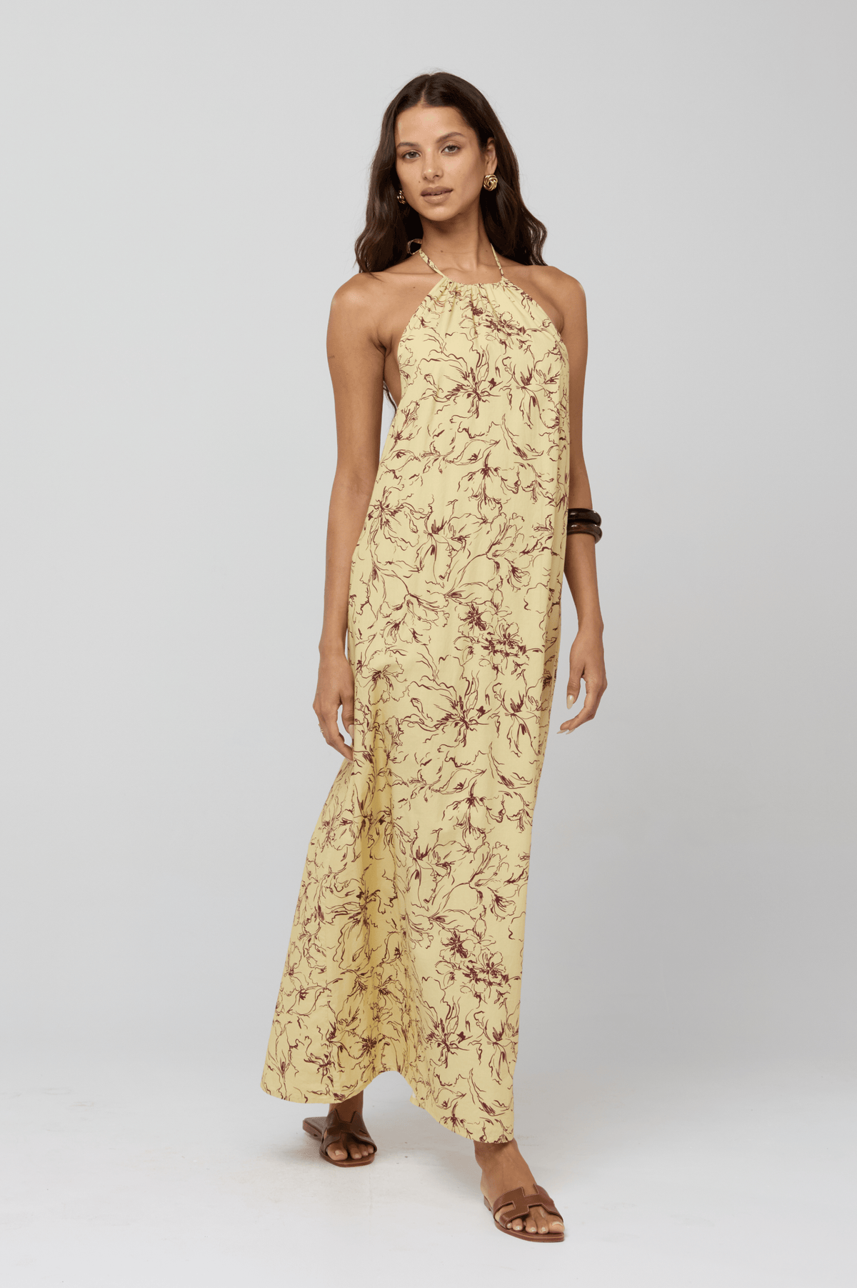 This is an image of Iris Halter Dress in Butterscotch - RESA featuring a model wearing the dress