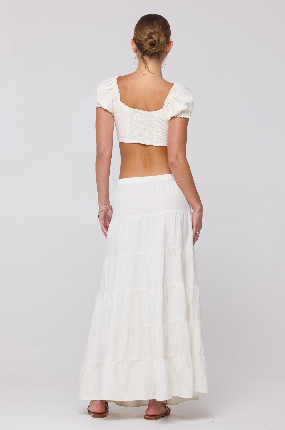 This is an image of Juliana Skirt in White Linen - RESA featuring a model wearing the dress