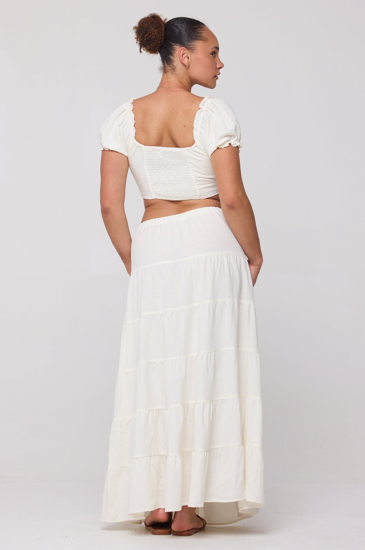 This is an image of Juliana Skirt in White Linen - RESA featuring a model wearing the dress