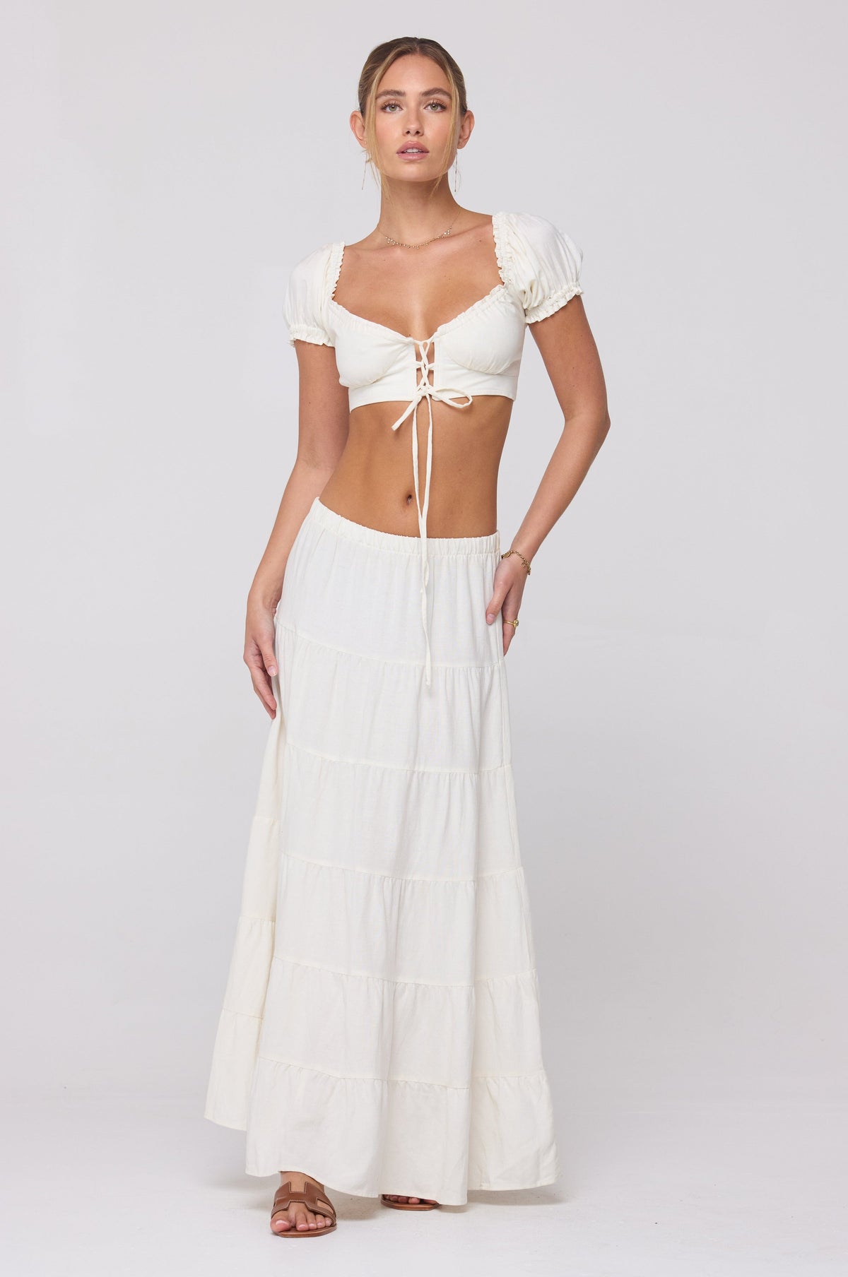 This is an image of Juliana Skirt in White Linen - RESA featuring a model wearing the dress