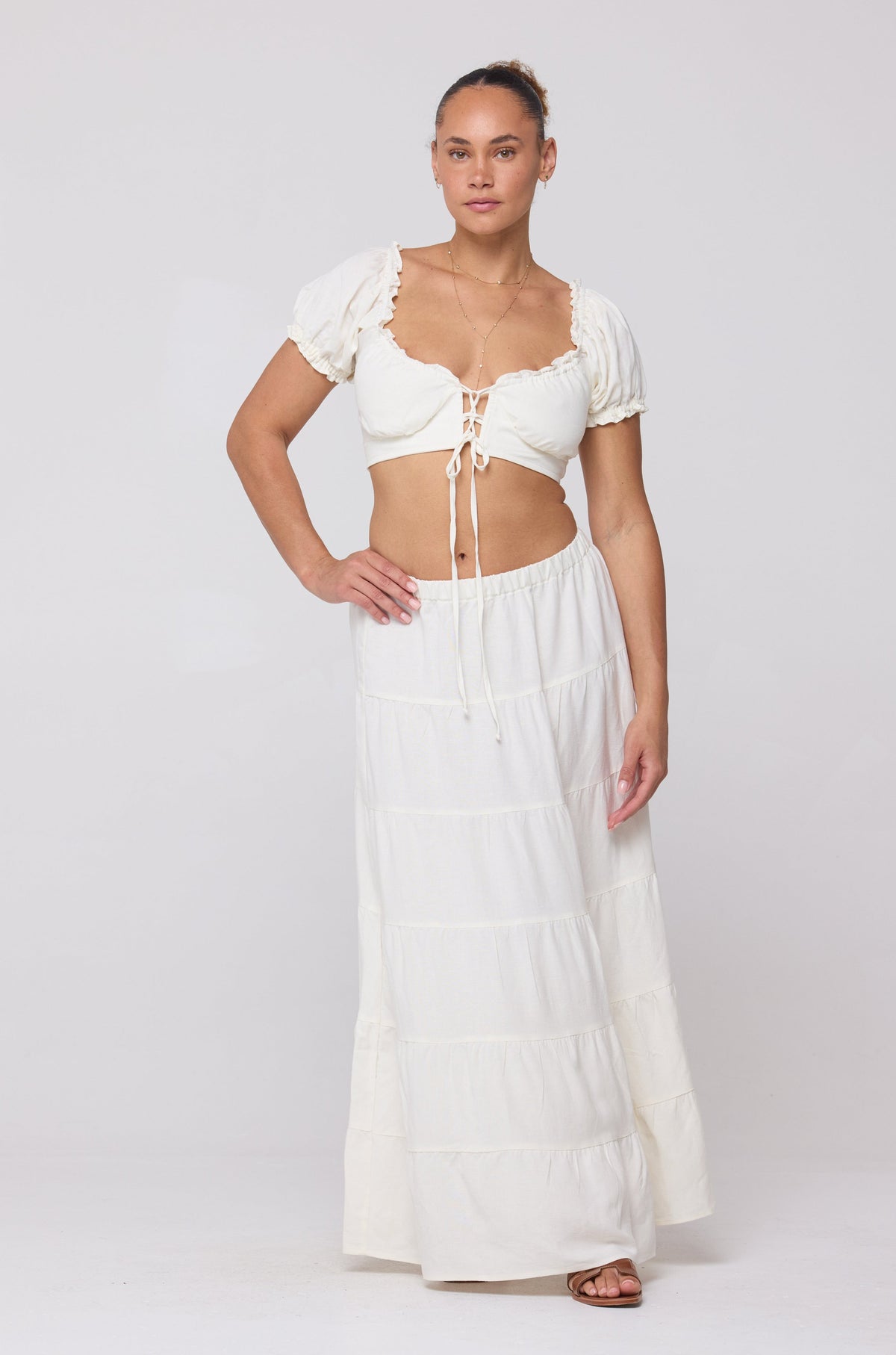 This is an image of Juliana Skirt in White Linen - RESA featuring a model wearing the dress