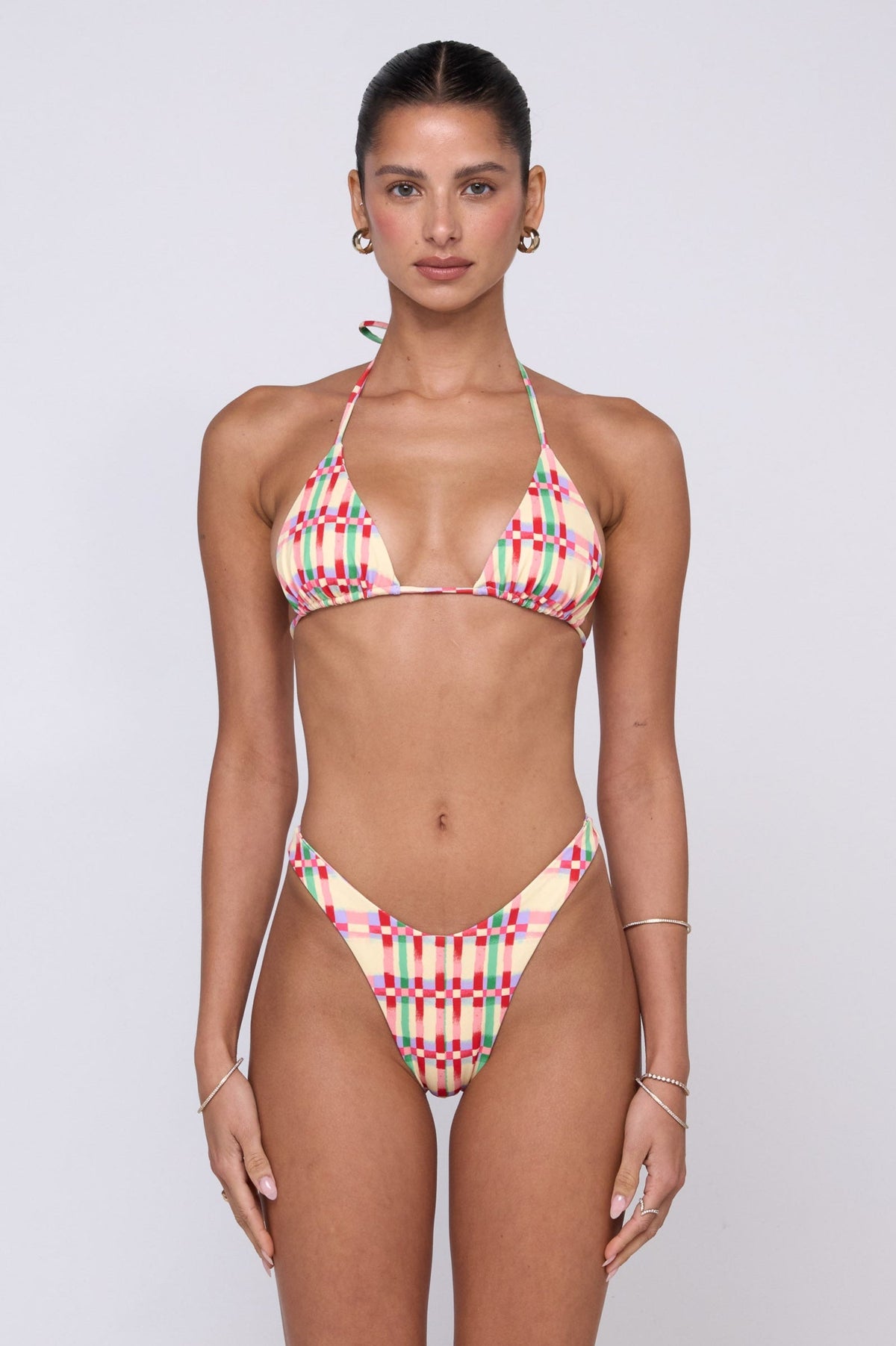 This is an image of Kyle Bikini Top in Plaid - RESA featuring a model wearing the dress